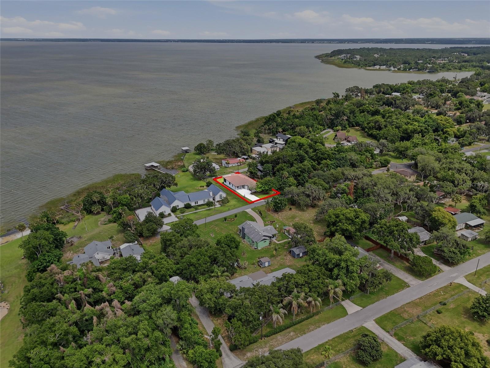Welcome to this stunning BRAND-NEW CUSTOM-BUILT home in the heart of Montverde, offering breathtaking VIEWS OF LAKE APOPKA and an unbeatable location just MINUTES FROM MONTVERDE ACADEMY. This exceptional 4-bedroom, 3-bathroom residence was thoughtfully designed to combine modern elegance, functionality, and quality craftsmanship. From the moment you enter, you'll be impressed by the OPEN-CONCEPT FLOOR PLAN, expansive living area, and abundance of natural light, creating the perfect space for both entertaining and everyday living. The CUSTOM GOURMET KITCHEN serves as the centerpiece of the home, featuring abundant custom cabinetry, GRANITE COUNTERTOPS, generous prep space, and a design that perfectly blends beauty with practicality. Luxury vinyl plank flooring flows throughout the home, creating a seamless and sophisticated look. The spacious primary suite is a true retreat, offering a LARGE WALK-IN CLOSET, spa-like soaking tub, and picturesque views of Lake Apopka. A versatile fourth bedroom provides the perfect space for a HOME OFFICE, guest suite, or flex room. Enjoy Florida living at its finest from the LARGE SCREENED-IN LANAI overlooking Lake Apopka, one of Central Florida's most iconic lakes, where you'll experience stunning sunsets, peaceful water views, and year-round outdoor enjoyment. Additional highlights include an INSIDE LAUNDRY ROOM WITH CUSTOM CABINETRY, an OVERSIZED TWO-CAR GARAGE, and ENERGY-EFFICIENT BLOCK FOAM CONSTRUCTION WITH SPRAY FOAM INSULATION. Located in the highly desirable Town of Montverde, this home offers convenient access to the Florida Turnpike, shopping, dining, and recreation while being just minutes from nationally recognized MONTVERDE ACADEMY. NEW CONSTRUCTION, LAKE APOPKA VIEWS, CUSTOM BUILT, ENERGY EFFICIENT, AND A PREMIER MONTVERDE LOCATION make this a rare opportunity to own a truly exceptional home in one of Central Florida's most sought-after communities.