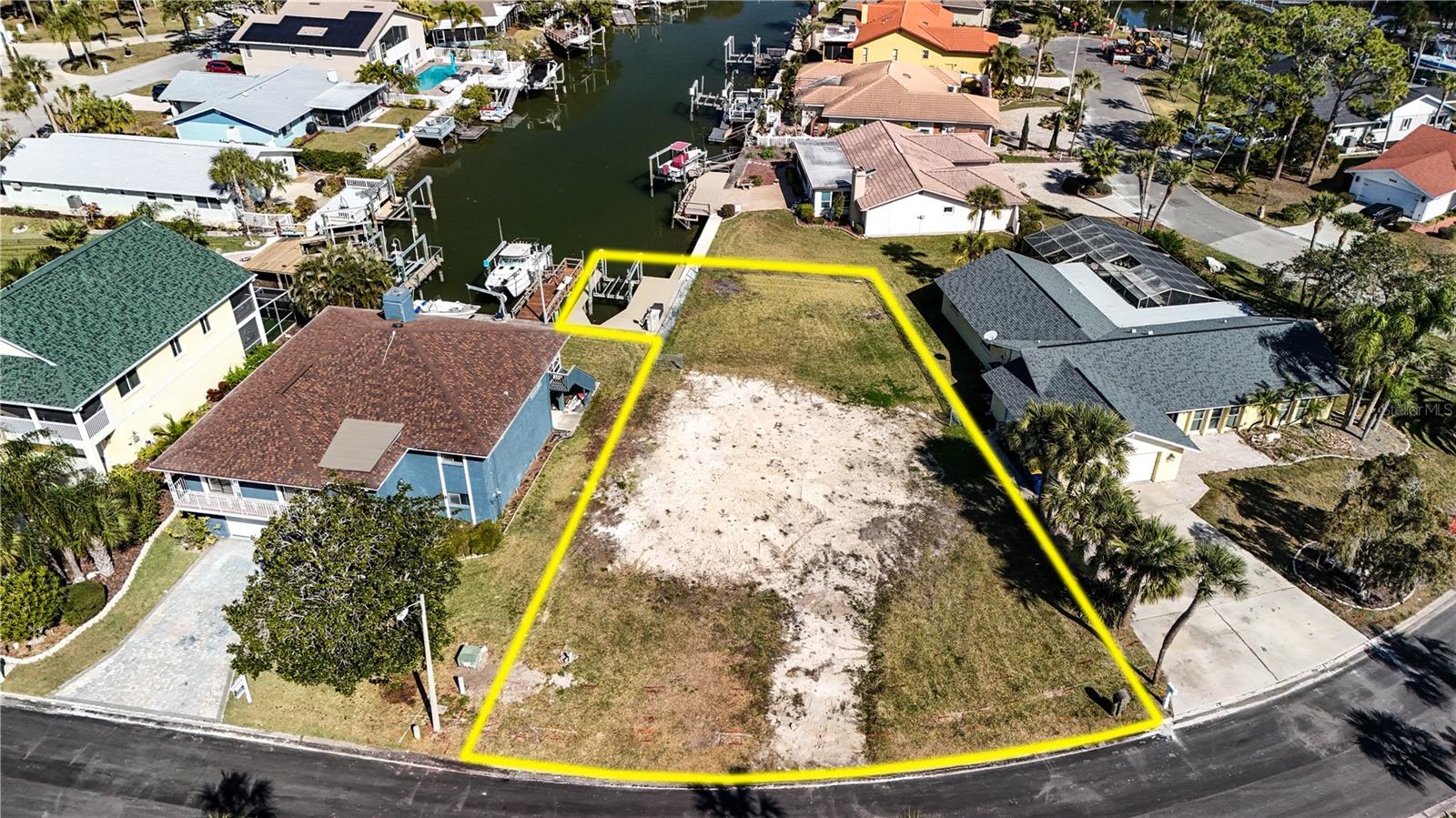 Waterfront living awaits in the highly desirable Gulf Harbors Woodlands Community of New Port Richey! Boat enthusiasts and lover of the costal living this is the place to build your dream home. Situated on 25-30 feet of serene waterfront, access to the Gulf of Mexico, this property includes a 13,000 lb boat lift with wooden dock (Pressure Treated) and wrapped Marine Pilings. Lot has been cleared and ready for you to build. Come and enjoy a boater's life for sure with easy access to the gulf, nearby island like Anclote Key and endless opportunities for fishing, diving, and exploring the near by water ways. Located close to Downtown New Port Richey, enjoy dining, shopping, Sims Park, and the Aquatica Center and so much more. Come and watch the Sunset of this relaxing waterfront retreat and enjoy the Gulf Harbor Lifestyle.