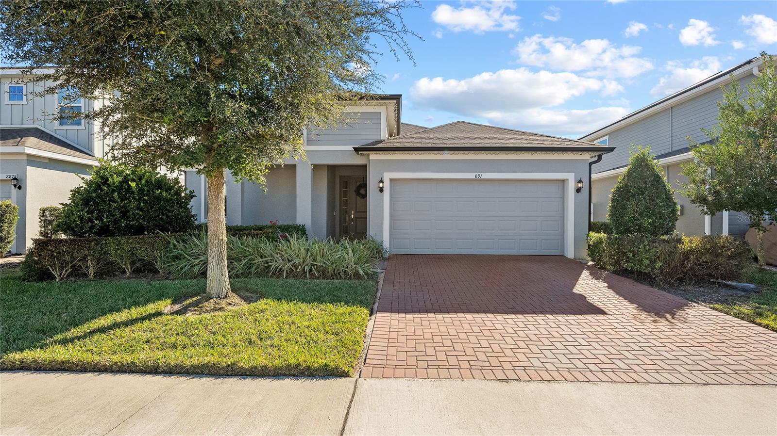 Built by Park Square Homes in 2021, this beautifully maintained one-story residence offers a thoughtful layout, quality finishes, and modern
conveniences throughout. Featuring 3 bedrooms, 2 bathrooms, and a versatile bonus room, the home is designed for both comfortable daily living and flexible use. The open-concept floor plan is enhanced by tile flooring throughout the main living areas and soft carpet in the bedrooms. A spacious kitchen anchors the home with granite countertops, 42-inch cabinetry, a walk-in pantry, and seamless flow into the living and dining spaces—ideal for entertaining. All appliances convey, including the washer and dryer, making this home truly move-in ready. The primary suite is a private retreat, offering two walk-in closets and a well-appointed bathroom with dual vanities, quartz countertops, a water closet, and a walk-in shower featuring a rainfall shower head. Each secondary bedroom also includes its own walk-in closet, providing ample storage throughout the home. Additional highlights include a two-car garage, pavered driveway, and a functional laundry room complete with a utility sink and custom cabinetry. A built-in mudroom adds everyday convenience and organization. The home is equipped with a security system and cameras throughout, all of which convey with the sale. Conveniently located near AdventHealth Fish Memorial Hospital and approximately 15 minutes from I-4, this home offers easy access for commuting while remaining in a well-kept residential setting. Thoughtfully designed, well cared for, and move-in ready, this property is an excellent opportunity for buyers seeking quality construction and modern features in a single-story layout.