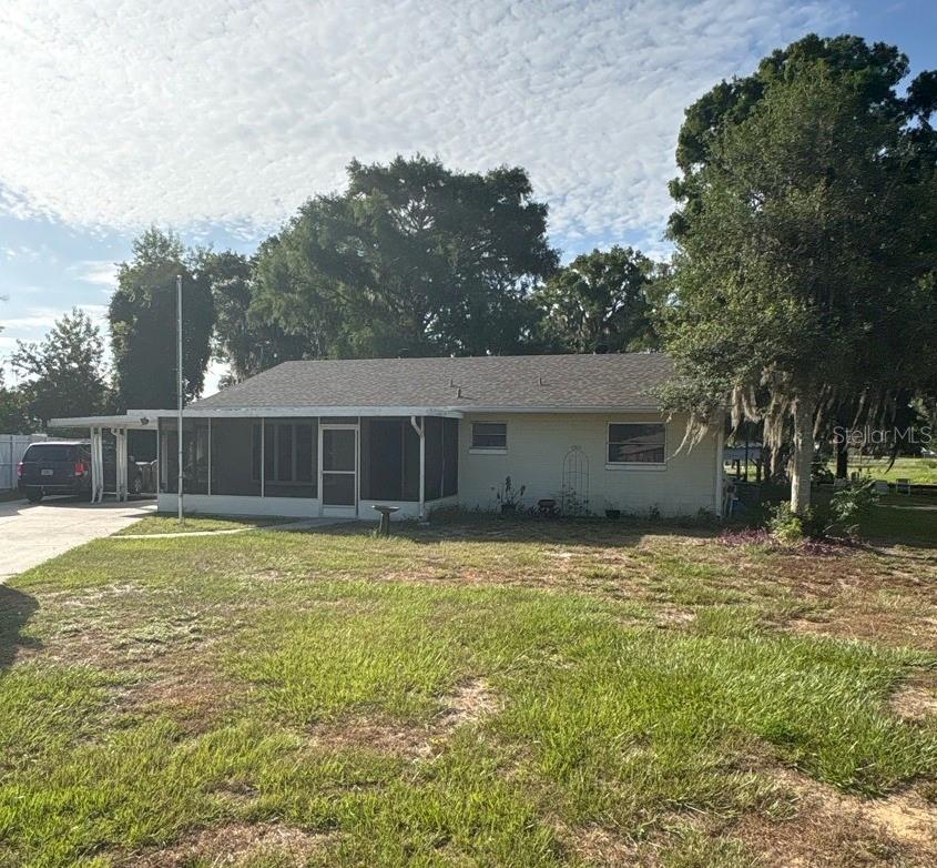 Waterfront Opportunity with Direct Access to Lake Eustis!

Enjoy the best of Florida waterfront living with this 2-bedroom, 2-bath concrete-block home situated on a canal with direct access to Lake Eustis and the Harris Chain of Lakes. Complete with a private dock and pontoon boat lift, this property is perfect for boating, fishing, and spending your days on the water—all from your own backyard.

Set on a generous 0.48-acre lot, the home features a functional layout with an open living and dining area, a kitchen just off the dining room, and sliding glass doors from both the kitchen and dining room leading to the screened back porch overlooking the backyard. A screened front AND back porch, long driveway, carport with attached storage room, and 2018 roof add to the home's appeal.

The interior is ready for updating, making this the perfect opportunity to renovate and create your dream waterfront retreat in an unbeatable location.