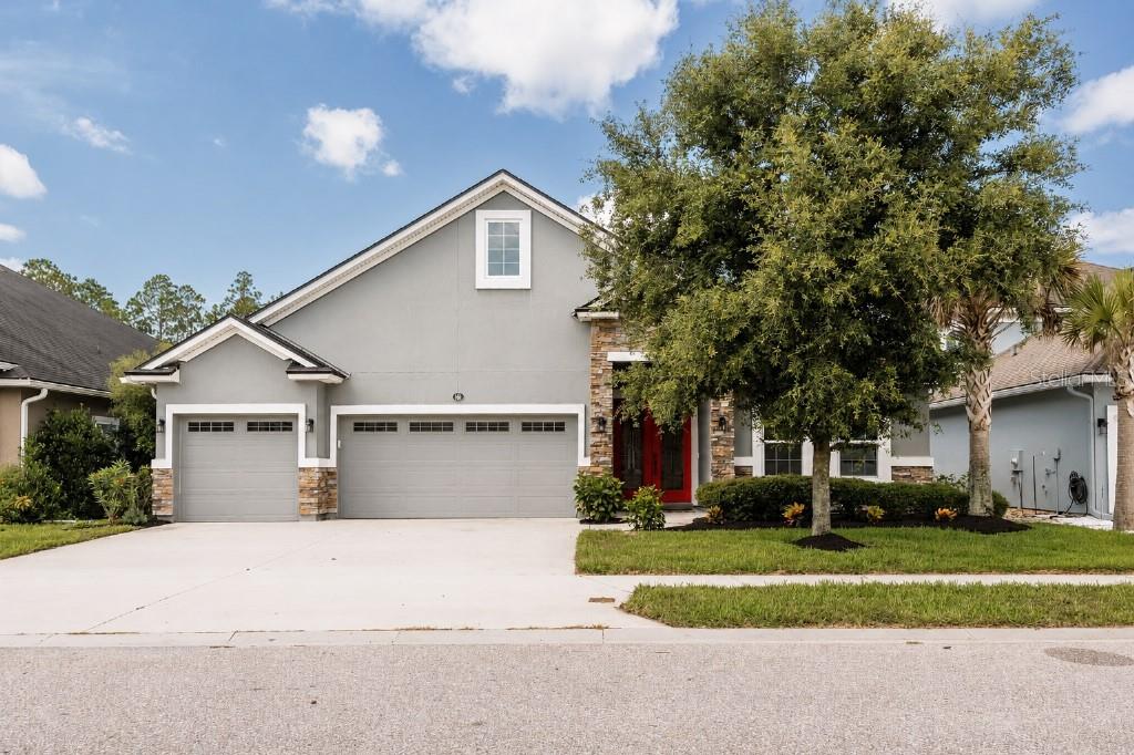 Heavily upgraded 5 bedroom, 4 bathroom home with a bonus room, perfect for a home-school studio, in-law suite, or multi-generational living. 3 car garage and large driveway to accommodate the whole family. Desirable gated Grand Landings community. Home backs up to a nature preserve with gorgeous views of turkeys, deer, hawks, and other wildlife. No homes will never be behind you!  You will be greeted by gorgeous 8 foot double glass doors, 9 foot double tray high ceilings, and crown molding throughout the home. The interior has been freshly painted and the walls are ready for your custom decor. Open concept living with beautiful finishes and features such as; wood look tile throughout main living area, high quality LVP in bedrooms and upstairs, a beautiful kitchen including Quartz countertops, 42” solid wood cabinets, Bosch stainless steel refrigerator and dishwasher, walk-in pantry, subway tile backsplash, farmhouse sink and custom shiplap oversized island. The huge dining and living room combo can fit all your friends and family with a custom stone accent wall as the center focus before you head out to the expanded screened-in patio with large pocket sliding glass doors. Fenced backyard with 20 foot paver patio is perfect for entertaining, with enough room for a relaxing fire pit area, dining table, and the grill gazebo. The large primary suite on the first floor also has a double tray ceiling, two walk-in closets, double vanities with Quartz tops, heart shaped garden tub, and custom tile and stone shower. All bathrooms all have floor to ceiling tile in the showers with upgraded shower heads, niches, and benches. The decorative staircase lead to the upstairs bonus room with a walk-in closet, full bathroom and and another large bedroom with walk-in closet. Many other upgrades and features include; whole house Rain soft water softener, two water heaters 
(2018 & 2024), walk in attic with plywood flooring and pull down ladder, huge storage room under the stairs, mudroom, indoor laundry room with Maytag washer & dryer (can be negotiated), living room prewired for surround sound, 5 camera security system with alarm, keypad entry, outdoor storage shed, and wifi irrigation. This house has it all and a low HOA gives you have access to the clubhouse with a zero-entry community pool, fitness center, dog park, and playground. It is just 5-10 minutes to i95, Town Center, shopping, hospital, restaurants, golf courses, tennis, pickle ball, the intracoastal, and the beach. Schedule your showing today for this perfectly upgraded family home!