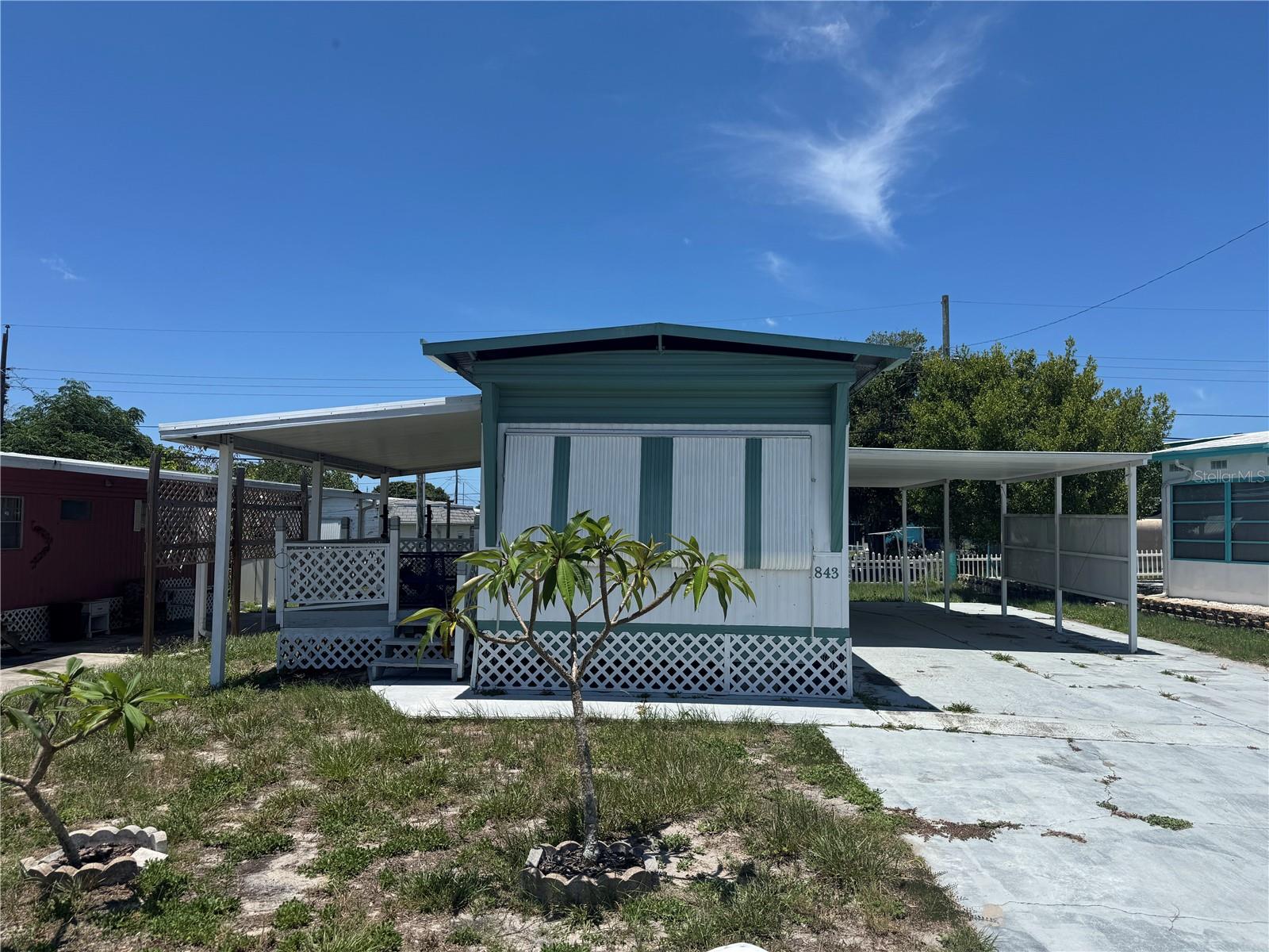 Nice mobile in Buena Vista South.  Big covered porch on one side and double width carport on the other.  Metal Roof Over.  Big primary bedroom with built in closets and drawers.  Nice big bathroom as well with updated fiberglass shower.  All appliances and the furniture that is there will remain.  Ready to move in.  Call Today!