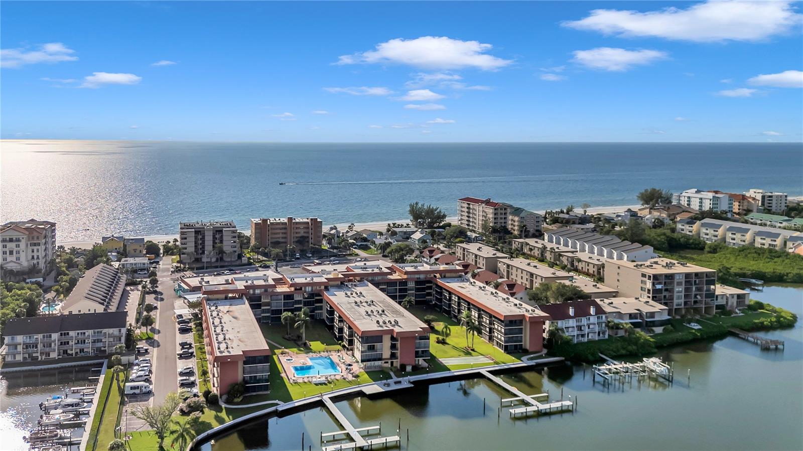 Huge price drop and a great opportunity to scoop up a deal on this beautiful unit.  Experience coastal luxury in this impeccably renovated 2BR/2BA residence, transformed from top to bottom with exceptional attention to detail. Every inch of this home has been thoughtfully updated—no corners cut, no finishes overlooked.

Step into a bright, sophisticated kitchen featuring premium appliances, gleaming quartz countertops, and upgraded shaker cabinetry. Both bathrooms have been reimagined with elegant tilework, upscale fixtures, and contemporary lighted mirrors. Custom-designed closet systems maximize storage while adding a boutique, high-end feel to each space.

Wide-plank light luxury vinyl flooring flows seamlessly throughout the home, creating a continuous, refined aesthetic with no transition lines. Modern square recessed lighting on dimmers sets the tone in every room, complemented by newly installed HVAC, water heater, windows, and sliders for peace of mind and efficiency.

Perfectly situated on the first floor, this condo offers effortless access and a serene connection to the outdoors. Step onto the private lanai and enjoy tranquil views overlooking the pool with a glimpse of the Intracoastal Waterway. Just a short stroll through the parking area brings you to a crosswalk leading directly to the beach, while an array of shops and restaurants sit conveniently at the front of the complex.

Live every day like you're on vacation—whether as your primary residence, a seasonal escape, or an excellent rental opportunity. Easy to show and ready to impress