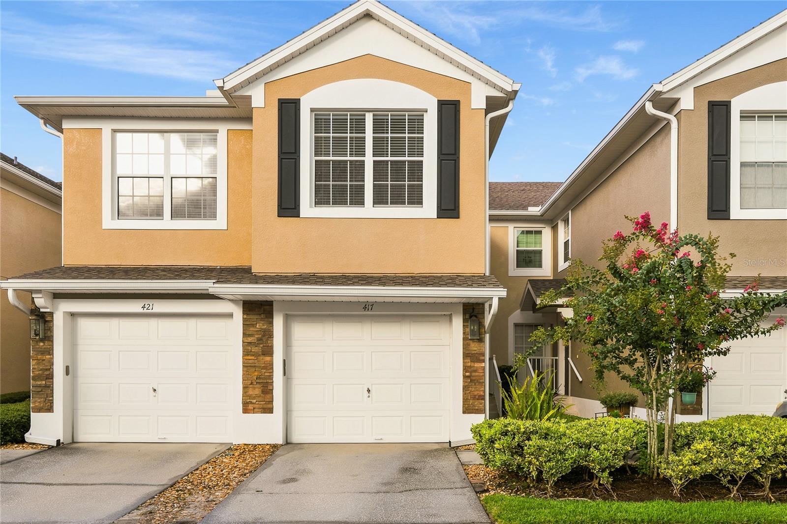 Hidden behind the private gates of Carriage Homes at Dunwoody Commons, you'll discover a beautifully maintained community where pride of ownership is evident throughout. Built by Pulte Homes, this quiet, gated neighborhood is known for its attractive curb appeal, well-kept grounds, and residents who take exceptional care of their homes. The community has been thoughtfully maintained, with roofs and exterior painting completed in recent years, and the HOA maintains healthy reserve funds for added peace of mind.

This second-story, single-level townhome welcomes you with an inviting stacked stone exterior that adds timeless charm. Inside, you'll find a bright, meticulously maintained interior with soaring ceilings that enhance the spacious, open feel. The well-designed floor plan seamlessly connects the kitchen and family room, creating an ideal space for everyday living and entertaining.

The kitchen is beautifully appointed with 42 inch white cabinets, Santa Cecilia granite countertops, and a stainless steel appliance package. Just off the kitchen is a conveniently located laundry closet for added functionality. The family room has newer laminate flooring. 

Expansive sliding glass doors lead to a spacious screened-in porch, filling the home with abundant natural light while creating the perfect indoor-outdoor living space to relax and unwind.

Major updates include a new roof (2023), new HVAC system (2022), and exterior painting completed in 2022, providing years of worry-free ownership.

Additional features include a one-car garage, ample guest parking, and low-maintenance living, as the HOA covers exterior maintenance and landscaping. Residents also enjoy access to a community pool and clubhouse with restrooms, offering wonderful amenities for relaxation and social gatherings.

Ideally located near local hospitals, the Seminole Wekiva Trail, top-rated schools, exceptional dining, and a variety of shopping destinations, this move-in-ready home offers the perfect combination of comfort, convenience, and a welcoming community atmosphere.
