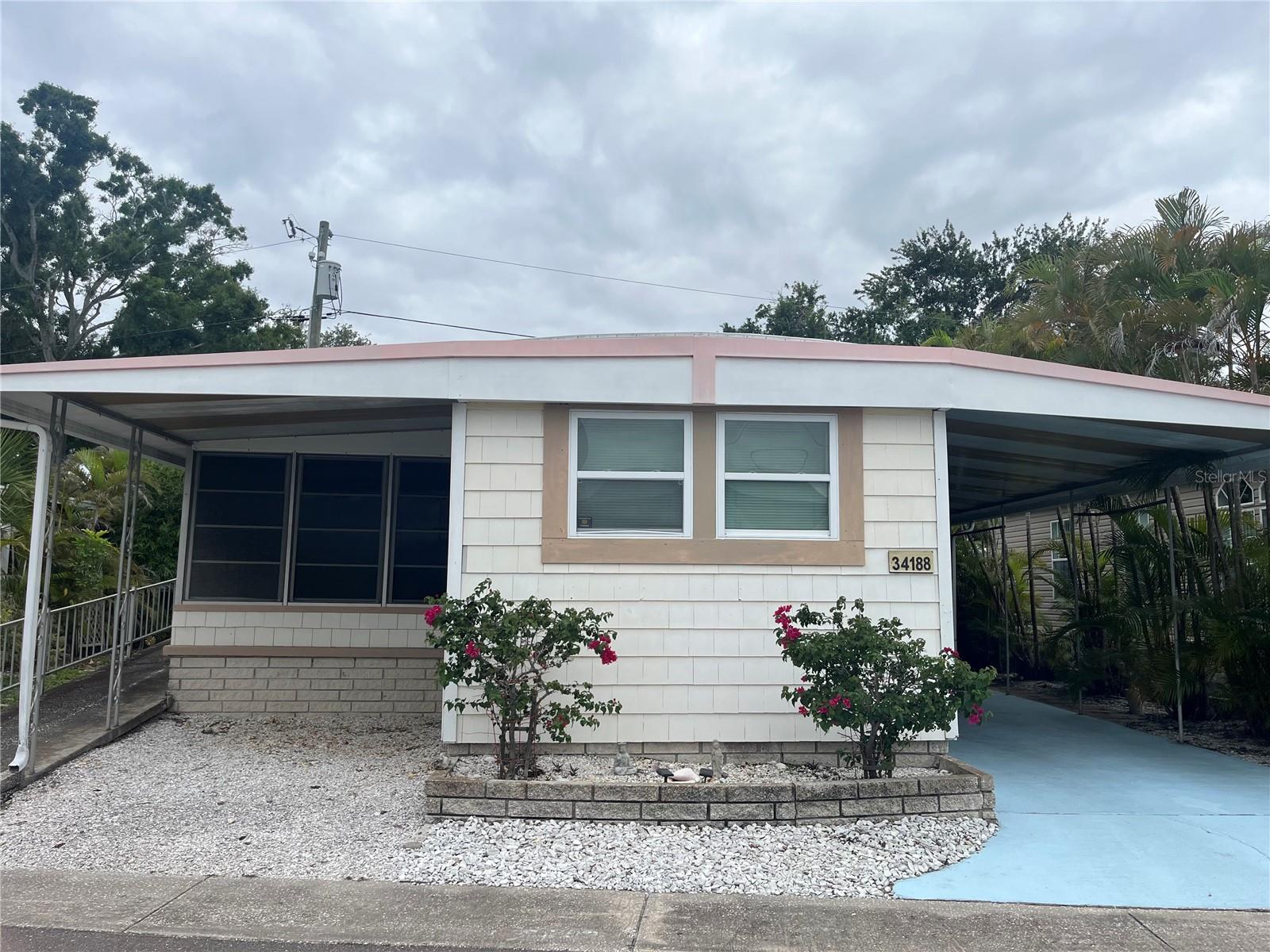 Affordable Florida Living in Sunset Palms – 55+ Co-Op Community.
Welcome to this charming 2-bedroom, 1-bath mobile home located in the desirable Sunset Palms 55+ community. Situated along a peaceful drainage canal, this home offers a relaxing setting and plenty of outdoor space to enjoy Florida’s beautiful weather.  Inside, you’ll find a comfortable floor plan plus a spacious Florida room, perfect for entertaining, hobbies, or additional living space. The property features a covered two-car carport with an additional parking area ideal for a golf cart. Residents of Sunset Palms enjoy an active lifestyle with an impressive selection of community amenities, including a clubhouse, pool, spa/hot tub, recreation facilities, shuffleboard courts, laundry facilities, and a variety of daily social activities and events. Conveniently located near I-275, shopping, restaurants, and Florida’s beautiful Gulf beaches, this home offers easy access to everything the area has to enjoy. Don’t miss your chance to own a piece of paradise in Sunset Palms—schedule your private showing today!