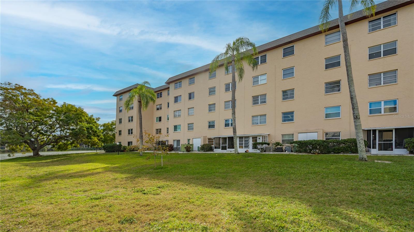 INCREDIBLE PRICE! Looking for the perfect blend of sunshine, simplicity, and a community that knows how to enjoy life? Welcome to Your Florida Lifestyle Condo! This charming 55+ condo checks all the boxes—and then some. Just a few miles from the Gulf. This home offers easy living in a friendly, active community where “retirement” is just another word for finally having time for fun. Morning coffee on your lanai? Check. Cocktails pool side? Check!  A social calendar that fills itself? Double check. This charming first-floor condo offers peaceful water views, modern updates, and absolutely no carpet—just easy-care Luxury Vinyl Plank flooring and a soft, Gulf-inspired color palette that makes every day feel like vacation. The kitchen shines with white quartz countertops and a full quartz backsplash, giving the space a clean, elegant look. Both bedrooms are comfortably sized, and the beautifully updated bathroom features a spacious no-step-in shower for ultimate ease and convenience. A rare bonus: your own full-size washer and dryer, neatly tucked into the all-weather lanai. Step outside and stroll to one of three community pools and the clubhouse—popular gathering spots where neighbors actually become friends. And when you’re ready for adventure, you’re less than 10 miles from some of Florida’s best Gulf beaches, including beautiful Anna Maria Island, plus plenty of dining and shopping close by. Whether you start the day with coffee or end it with a cocktail on your lanai, you’ll love the feeling that you’ve truly found your condo home.