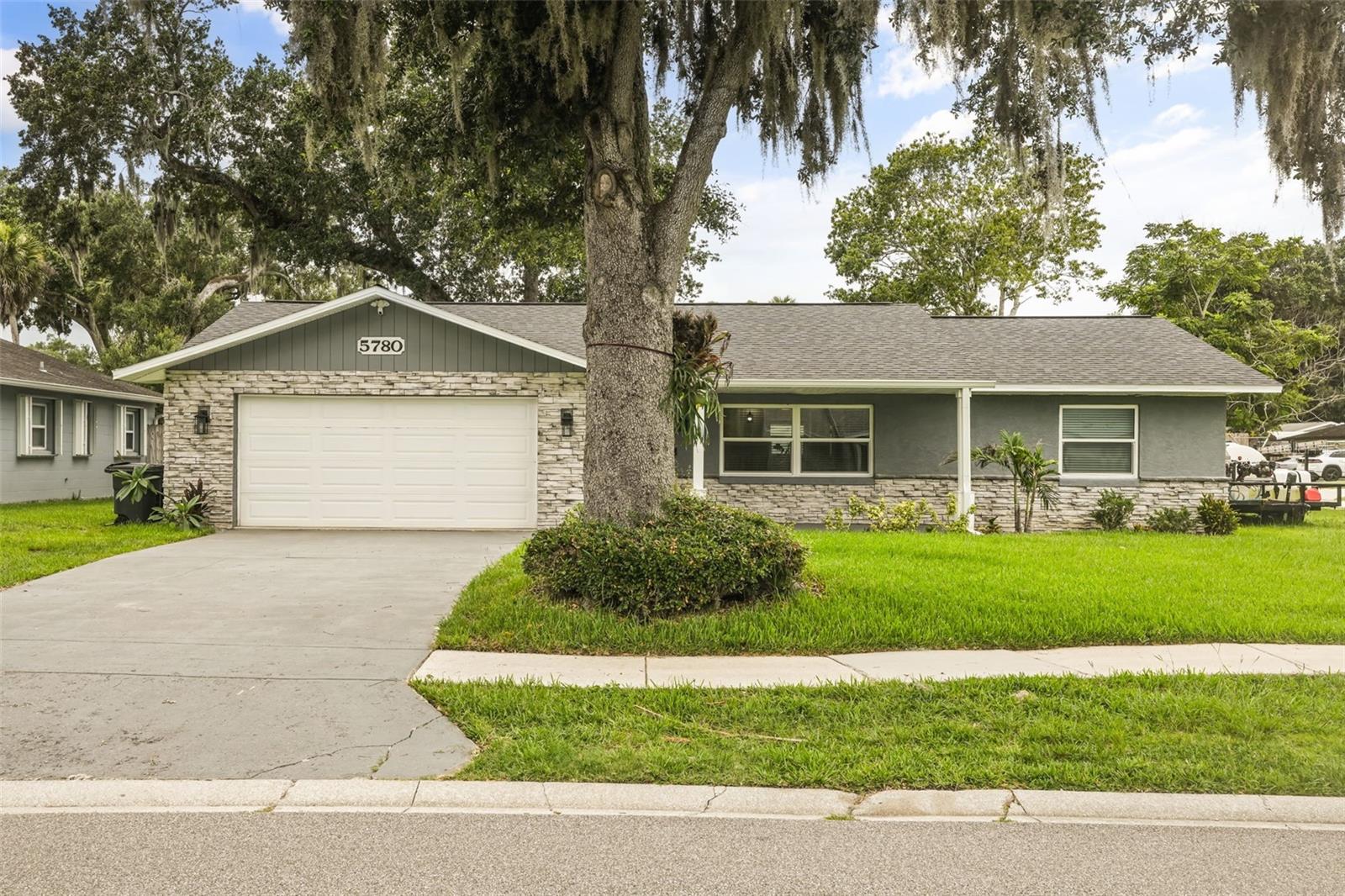 Virtually Staged. Welcome home to this beautifully updated 3 bedroom 2 bathroom corner lot gem in the heart of Port Orange! With no HOA, you have the freedom to bring your RV, boat, and all your toys. Zoned for the highly sought after Spruce Creek Elementary and Creekside Middle School, this home checks all the boxes for families. Enjoy the convenience of being just minutes from All Children's Park, Neighbor's Ice Cream, and only 10 minutes to the beach. Step inside and fall in love with a home that has been thoughtfully remodeled from top to bottom and is truly move-in ready. The kitchen shines with custom cabinets and stunning granite countertops, both updated in 2024. Beautiful new flooring flows throughout the home, and the master bathroom has been fully renovated. The second bathroom received a stylish new vanity as well, all in 2024. Major systems have been taken care of too, with a new roof in 2021, updated windows around the same time, and a brand new tankless water heater installed in 2024. AC is approximately 10 years old. Whether you are a first time buyer or looking to downsize, this one has it all.