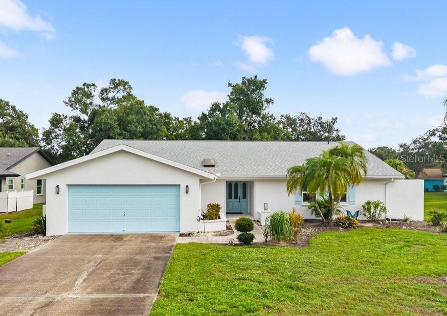 An exceptional opportunity in the highly sought-after Center Gate Estates community ! This beautifully updated home with peaceful pond views welcomes you with a leaded glass entry door and an inviting living room. Cottage-inspired finishes include soft taupe tones, white shaker-style cabinetry, moldings, and trim throughout. Porcelain tile flooring, vaulted ceilings, five skylights, IMPACT WINDOWS, and impact sliding doors fill the home with abundant natural light. Upgraded lighting includes two elegant chandeliers on dimmers, adding warmth and sophistication. The open kitchen and family room create an ideal space for everyday living and entertaining, featuring an eat-in breakfast area and a formal dining room highlighted by a stunning crystal chandelier. The generous primary suite offers vaulted ceilings, walk-in closets, dual sinks, a make-up vanity, a spacious garden tub, and a large tiled walk-in shower. Three impact-resistant sliding glass doors open to an oversized screened lanai with three ceiling fans, creating the perfect indoor-outdoor living space. Enjoy the peaceful ambiance of the pond, complete with bird, ducks, and other wildlife, from the expansive lanai, which provides a tranquil setting. Additional highlights include a separate laundry room with a newer washer and dryer, a spacious two-car garage, a NEW HVAC system (April 2025) with a transferable warranty, upgraded lighting, and a 2021 ROOF. Ideally located just minutes from shopping, fine dining, I-75, world-renowned beaches, and top-rated schools, this exceptional home offers the perfect blend of timeless charm, thoughtful updates, and serene Florida living with relaxing water views.
