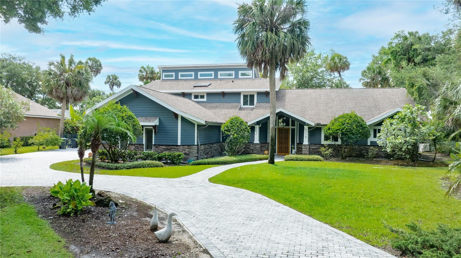 Welcome to Palmas Bay, one of Port Orange's most desirable gated waterfront communities. This custom riverfront home offers the kind of views and privacy that are becoming harder to find. Situated across from the protected Doris Leeper Preserve, you'll enjoy a natural backdrop with no homes or future development across the water—just endless views, wildlife, beautiful sunsets, and the peaceful Florida lifestyle you have been dreaming about.
With 4 bedrooms, 4.5 bathrooms, and an expansive 3-car garage, the home is thoughtfully designed to accommodate everyday living, visiting guests, hobbies, and effortless entertaining. The versatile floor plan features a private downstairs guest suite with its own bathroom, an additional guest bedroom, and a convenient pool-access half bath that makes indoor-outdoor living easy.
The kitchen flows naturally into the family room, creating an inviting central gathering area framed by a fireplace and tranquil water views. Nearby, a light-filled sunroom offers the perfect spot to sip morning coffee while boats drift along the river. The main level also includes a generous formal living room, ideal for hosting holidays, celebrations, and memorable get-togethers.
The primary suite is tucked away upstairs and feels like a private retreat. Features include a fireplace, private office, oversized walk-in closets, double vanity, and a private balcony overlooking the backyard and river. An adjoining fourth bedroom provides flexibility for a nursery, fitness room, second office, sitting room, or additional guest space.
Step outside and discover what makes this property truly special. The backyard was designed to enjoy waterfront living with a private dock, pool, spa, multiple firepit areas, mature landscaping, storage shed, and a unique treehouse that could be used as a play space, art studio, reading retreat, or creative workspace.
Whether you enjoy boating, kayaking, paddleboarding, fishing, entertaining friends, or simply relaxing by the water, this property offers something for everyone. The oversized garage provides plenty of room for vehicles, golf carts, tools, and recreational equipment.
Palmas Bay is known for its beautiful waterfront homes, privacy, and convenient location near shopping, dining, golf courses, medical facilities, and some of Central Florida's most beautiful beaches. You're just minutes from New Smyrna Beach, Daytona Beach Shores, Ponce Inlet, and all the outdoor recreation the area has to offer.
Properties with protected preserve views, private docks, flexible living spaces, and this much outdoor enjoyment rarely become available. If you've been searching for a true waterfront estate with room to spread out, entertain, and enjoy everything Florida living has to offer, this home deserves a closer look.