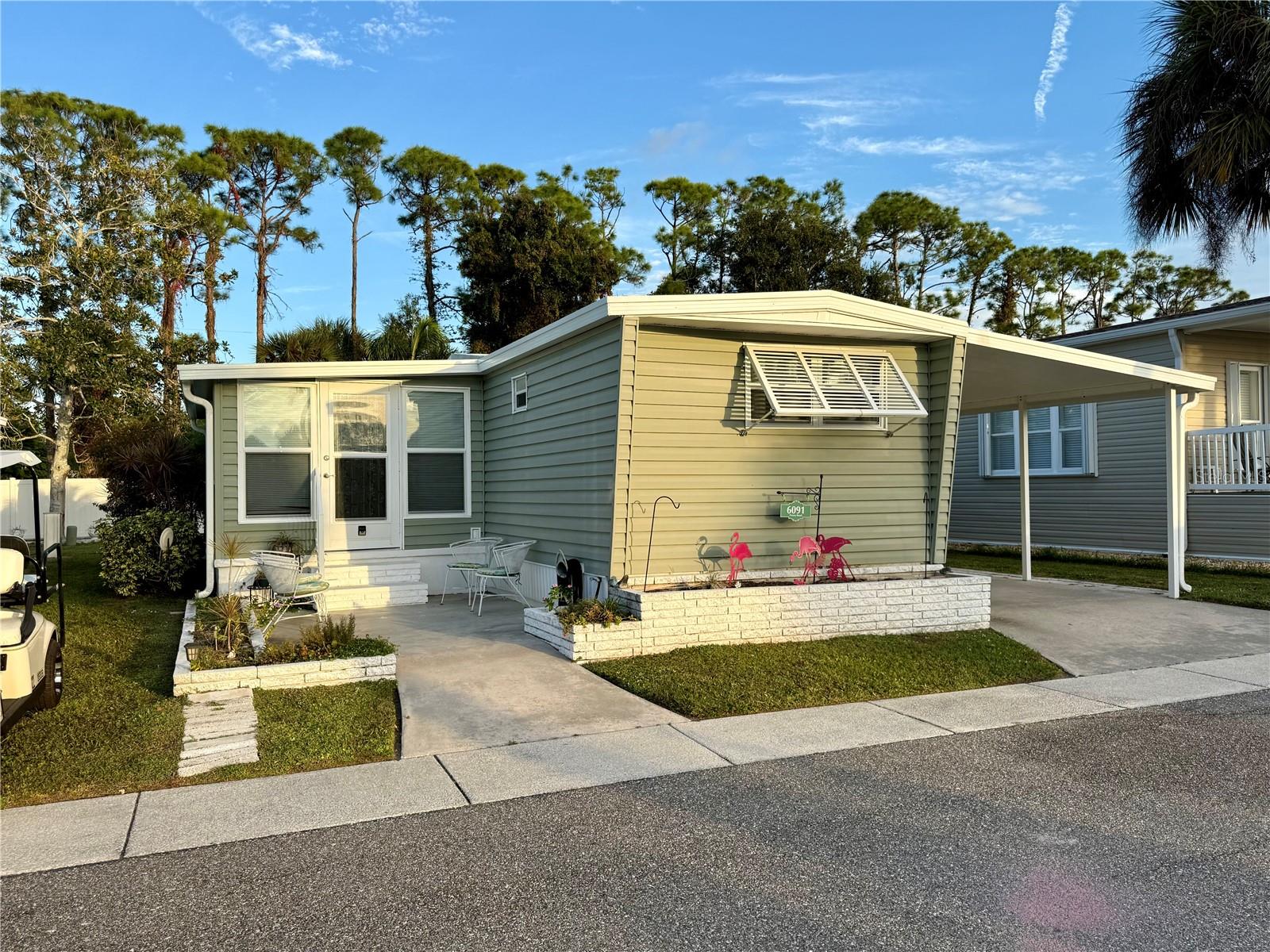 Welcome to 6091 Peony Road, located in the well-maintained Japanese Gardens community in Venice, Florida. This 2-bedroom, 2-bath residence offers a comfortable and practical layout, ideal for seasonal or year-round living in a convenient Gulf Coast location. 

The home features an open floor plan with a bright living and dining area, complemented by a functional kitchen with breakfast bar. The split-bedroom layout provides privacy, and the primary bedroom includes an en suite bath and dual closets. The property is being offered furnished, allowing for immediate use or rental potential. 

An enclosed sunroom adds additional living space and flexibility, while the covered carport and attached storage provide everyday convenience. The exterior includes low-maintenance features and a manageable lot within a private, sidewalk-lined community setting. 

Japanese Gardens is a resident-owned community offering amenities such as a clubhouse, community pool, and organized social activities. The monthly fee includes cable, water, sewer, and recreational facilities, supporting a simplified and maintenance-conscious lifestyle. 

The location provides easy access to Manasota Beach, downtown Venice, and the shopping, dining, and entertainment options of Wellen Park. This property offers a balance of privacy and accessibility in a well-established Sarasota County community. 

This property presents an opportunity for buyers seeking an affordable, low-maintenance residence in a centrally located Venice community. Schedule your private showing today.