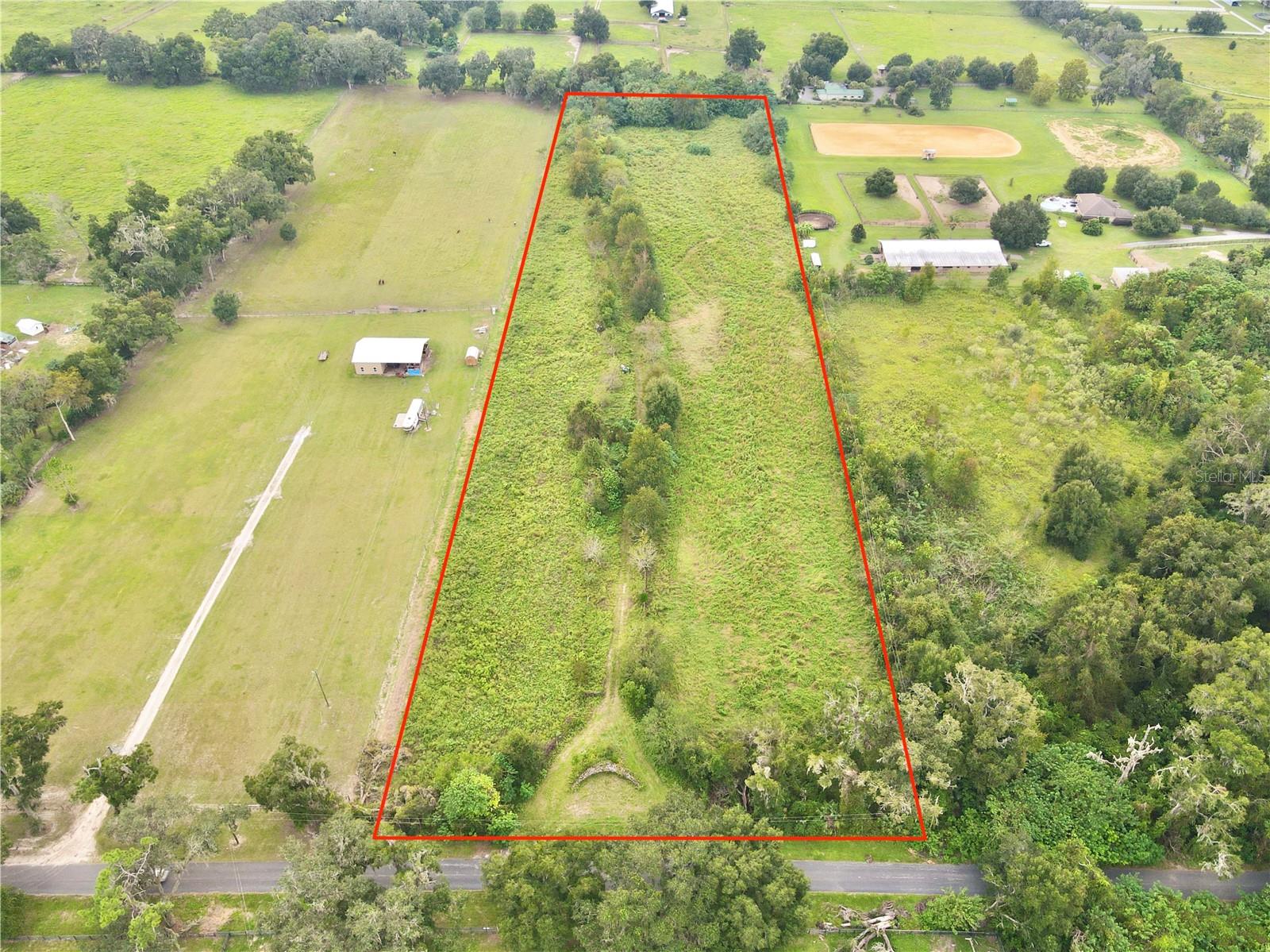 An exceptional opportunity for equestrian and agricultural enthusiasts, this 10-acre vacant, cleared parcel offers the ideal setting for a farm or private horse property. The land is high and dry with a beautiful tree line providing natural privacy and a picturesque backdrop for barns, paddocks, or a future residence. Zoned for agricultural use, this property supports a wide range of farming and equestrian uses. Electric poles are already installed in the easement, helping streamline future development. Located just 17 miles from the World Equestrian Center and 13 miles from downtown Ocala, it combines peaceful rural living with convenient access to premier equestrian venues, shopping, and dining. A prime piece of Ocala-area land perfectly suited for horses, farming, and country living.
