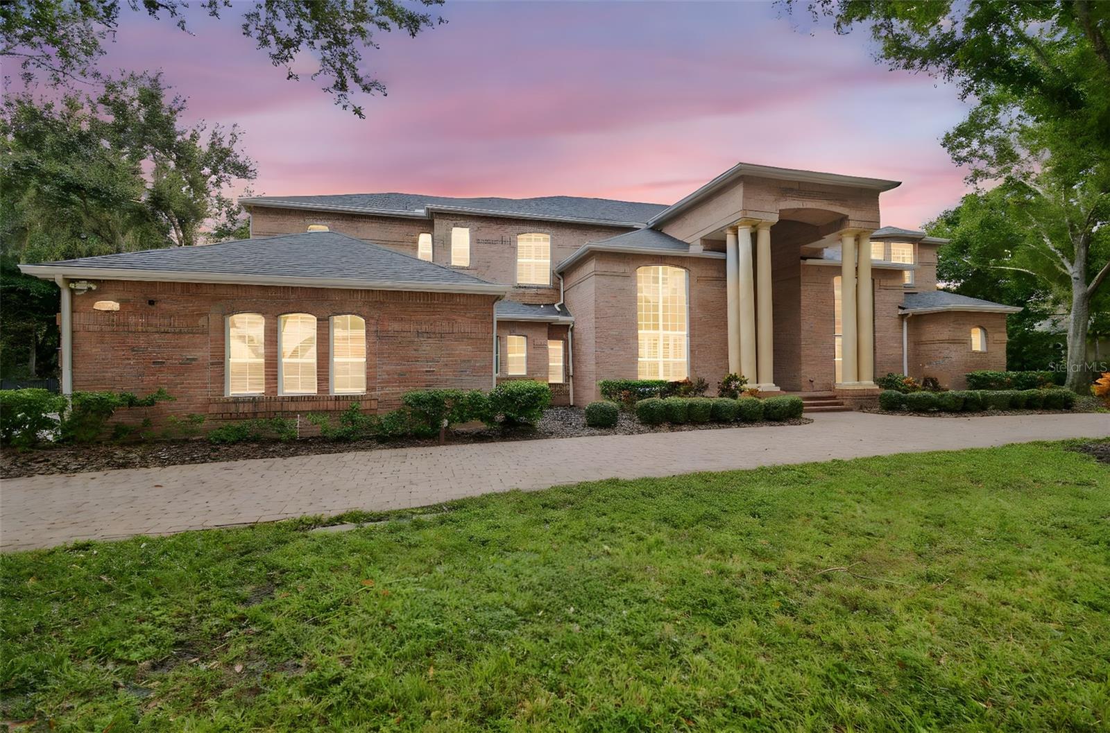 Welcome to this an exquisite one of a kind custom-built brick estate that embodies refined luxury and sophistication. This house is perfectly situated on a double lot of 1.5 acres in one of Tarpon Springs’ most sought-after luxurious neighborhoods. This magnificent home offers both privacy & grandeur, minutes from Gulf beaches, charming downtown shops, and top-rated schools. All with Brand New Roof & 3 newer HVAC systems.

As you drive up the circular paved driveway & enter through the double entry doors, you’re greeted by a breathtaking two-story foyer that opens to a formal living room with a circular staircase, soaring ceilings and sweeping views of the estate grounds.  Stunning gold-plated crystal chandeliers and a custom-made bookcase, serve as the centerpieces of the formal living room adding a touch of timeless elegance.  On the right, an executive office/ library with exquisite built in cabinetry overlooks the front yard, offers a peaceful retreat or quiet place to work. Every detail of this home reflects exceptional craftsmanship—from the rich millwork & triple crown moldings to the hand-finished cabinetry & architectural detailing throughout.

The chef’s kitchen is a masterpiece, featuring a large crystallite granite island, custom wood cabinetry, and premium stainless-steel appliances. A walk in pantry for storage. Across from kitchen, there is a stately formal dining room framed with Roman columns sets the stage for elegant dinner parties.

The home’s interior showcases marble, tile and rich hardwood flooring, complemented by arched doorways, art niches, and designer lighting. The two-story family room impresses with a built-in entertainment center, a fireplace and grand windows that fill the space with natural light. 

Each bedroom suite is generous in size including a walk-in closet, offering comfort and privacy for family and guests. Two bedrooms with ensuite bathrooms are located on the first floor, one on each side of the house.  There is also a guest half bathroom on the first floor.  The master primary suite is on the second floor, featuring its own fireplace, a spa-like marble bathroom, column surrounded garden tub, a walk in granite shower,  and two walk in closets.  The split plan offers two more bedrooms and a full bathroom on the other side of the second floor.  A second staircase, a small loft and a huge balcony overlooking the backyard allow for enjoyable views. 

Step outside to your private backyard oasis—complete with a sparkling pool and spa, paved travertine deck, surrounded by lush landscaping and calm pond, perfect for entertaining or unwinding in style.  Pool has a separate full bathroom that was recently remodeled.  A three-car side-entry garage and large side driveway, and side fenced yards for pets complete this extraordinary property.

This residence is part of a large gated community with security guards. Community features a clubhouse, golf course, and a private restaurant.  Location is key as it is a short drive to many florida beaches, Tarpon Springs sponge dock, many marinas, and about 30 minutes away from Tampa Internation Airport and St. Petersburg airport.  The community is surrounded by many shopping centers, county parks and close to major roads and highways which makes it the perfect location in the midst of everything.  

Experience the perfect blend of elegance, comfort, and timeless design in this remarkable Tarpon Springs estate.