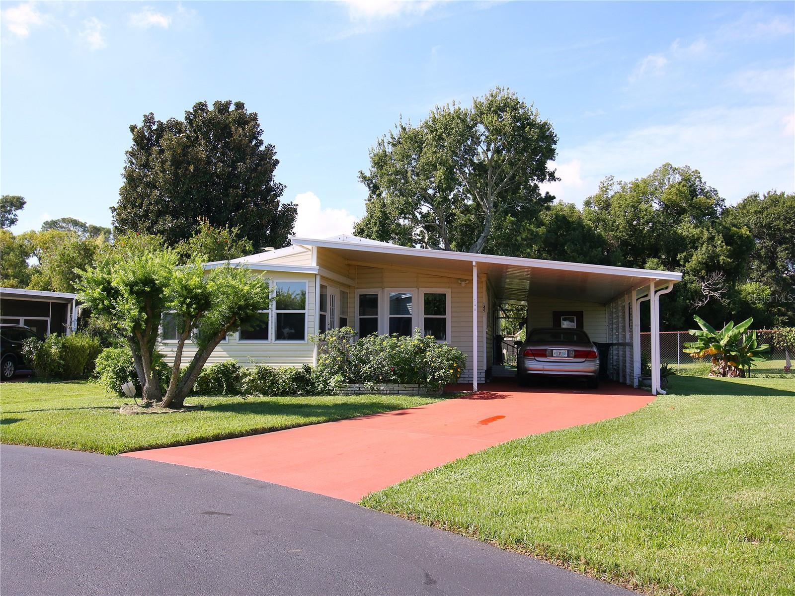 One or more photo(s) has been virtually staged. Own your land in this highly desirable 55+ lakefront community with an exceptionally low HOA fee of just $39 per month. This well-maintained two bedroom, two bath home offers an excellent opportunity for buyers searching for affordable Florida retirement living with lake access and low monthly expenses in Polk County.

Situated on a beautifully maintained lot, the home provides comfort, functionality, and easy living. The eat-in kitchen features a large bay window that fills the space with natural light, creating a bright and welcoming atmosphere. Hurricane-rated windows throughout the home offer added security, durability, and energy efficiency. A separate dining room provides dedicated space for entertaining guests or hosting family gatherings.

Outdoor living is a highlight of this property, with a 10x12 Florida sunroom porch ideal for morning coffee or evening relaxation, and a 12x13 back patio perfect for enjoying Florida’s year-round sunshine. The manageable lot size allows for outdoor enjoyment without excessive maintenance.

Residents of this 55+ community enjoy access to a clubhouse with social activities such as potlucks, bingo, cards, a community pool, and shuffleboard. The neighborhood also provides private access to Lake Marianna with a dock and boat ramp, making it ideal for buyers searching for a lakefront community in Central Florida with boating and fishing opportunities.

Additional features include a separate secure storage shed with a dedicated laundry area, offering extra convenience and storage space. This property is ideal for buyers seeking a low HOA 55+ home in Florida where you own the lot, enjoy community amenities, and benefit from lake access in a peaceful setting.