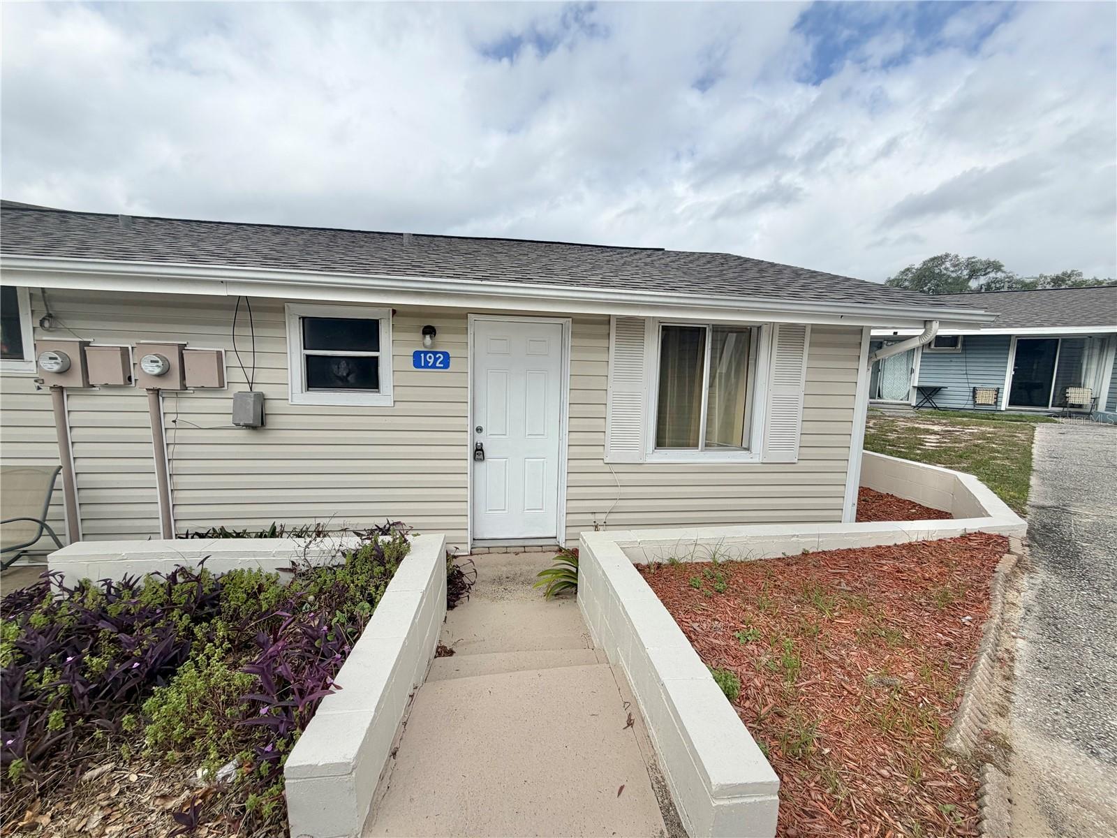 GREAT INVESTMENT, LONG TERM AND SHORT TERM RENTALS ALLOWED! *HOA INCLUDES MOST EVERYTHING-Cable/Internet, Water, Sewer, Pest Control, Termite Protection, Exterior Maintenance (WHICH INCLUDES OUTSIDE PAINTING AND ROOF REPLACEMENTS), Mowing/Landscaping, CHAIN OF LAKES Access, Boat Dock, Boat Ramp, Heated Olympic Size Pool, Pickleball, Tennis, Shuffleboard, Basketball, Playgrounds, RV & Trailer Storage and more. Come home to serenity in the charming community of Vacation Village. This quaint FURNISHED 2 Bedroom 1 Bath condominium freshly painted inside and outside would be perfect for a Winter Resident, couples starting out, or anyone looking to downsize. A brand new 2025 roof.   Relax in front of your electric fireplace that will also help keep you warm during the winter months. Enjoy your newly screened porch with sitting area. The stove and refrigerator are 1 year old. The condo is located on property that spans across many acres with beautiful trees and amenities galore. (see above) Perfect as your own bungalow, or investment rental property as many other condos in the community have been very successful with short term and long term rentals. Vacation Village is a Gated Community located on Lake Louisa ---- part of the Clermont Chain of Lakes. Vacation Village consists of a combination of 193 A-Frames and Villas. Just 20 minutes from Disney and the attractions; located on Hwy 27 south of Hwy 50; Close to the Clermont Trail system, Publix Plaza and across the street from the planned 250 acre Olympus Sports Complex!
