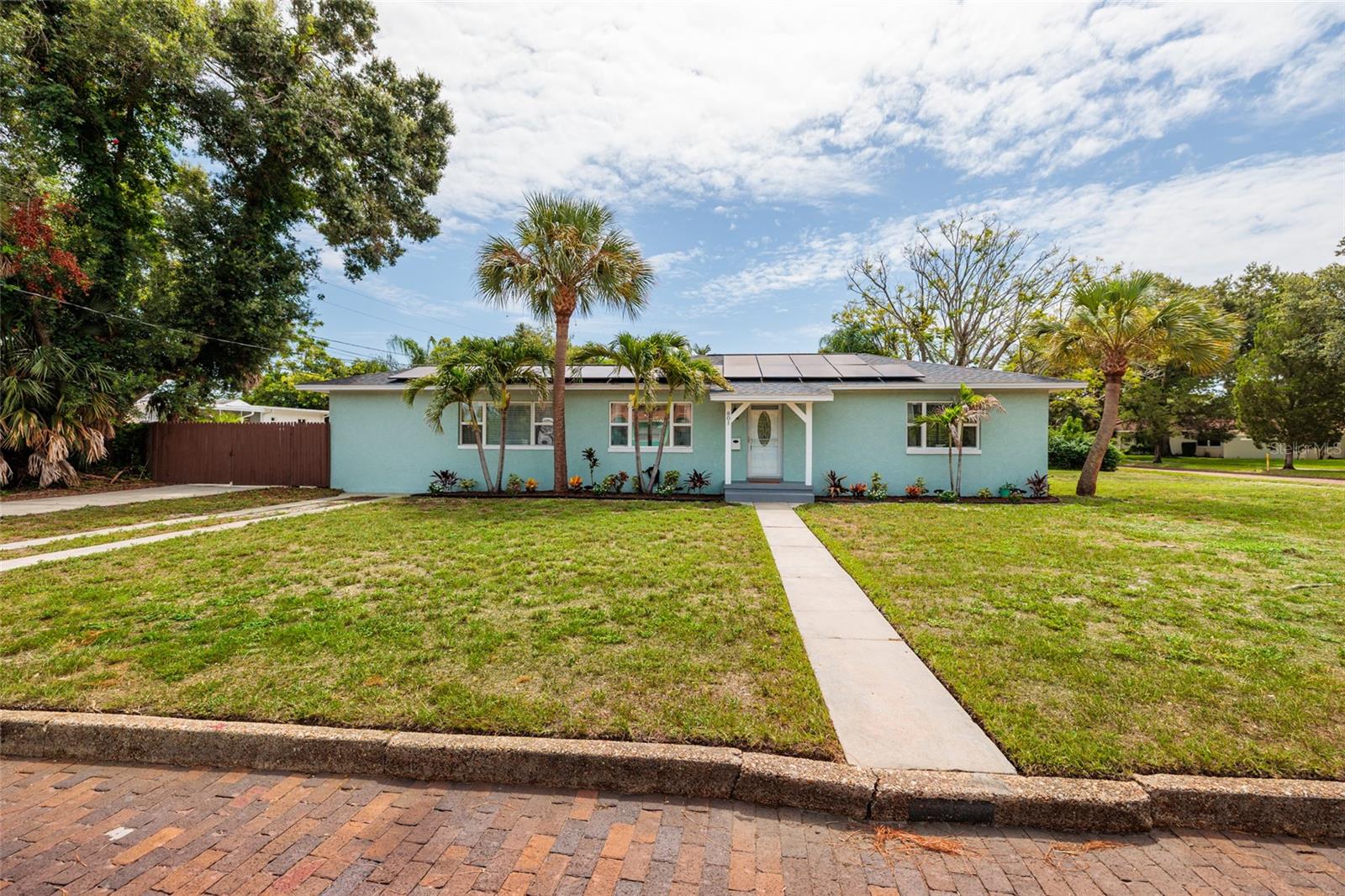 HIGH & DRY. BIG BACKYARD. ZERO FLOOD INSURANCE. Welcome to one of St. Pete's favorite neighborhoods—Eagle Crest—where charming brick streets and mature trees set the stage for this sunshine-filled concrete block home.  
Inside, natural light pours through every room, highlighting the original hardwood floors and beautifully updated spaces. The kitchen features warm white cabinetry, granite countertops, a glass subway tile backsplash, stainless steel appliances and a center island that's perfect for everything from morning coffee to gathering with friends. Two remodeled bathrooms make this home completely move-in ready.
The split-bedroom floor plan offers 3 bedrooms, 2 baths and a versatile bonus room off the primary suite—ideal for a home office, nursery, gym, reading room or private retreat.
Step outside and discover what may be the home's biggest surprise—a spacious, fully fenced backyard with room to entertain, garden, play with the dog or simply unwind after a long day. Park your RV/boat behind the double gate for extra storage and convenience.
And here's what every Florida buyer wants to hear: No flood insurance required. Add concrete block construction, a 2018 metal roof, owned solar panels, wind mitigation credits and low utility costs, and you've found a home that's as smart as it is charming. Plus, a great central location in St. Pete!