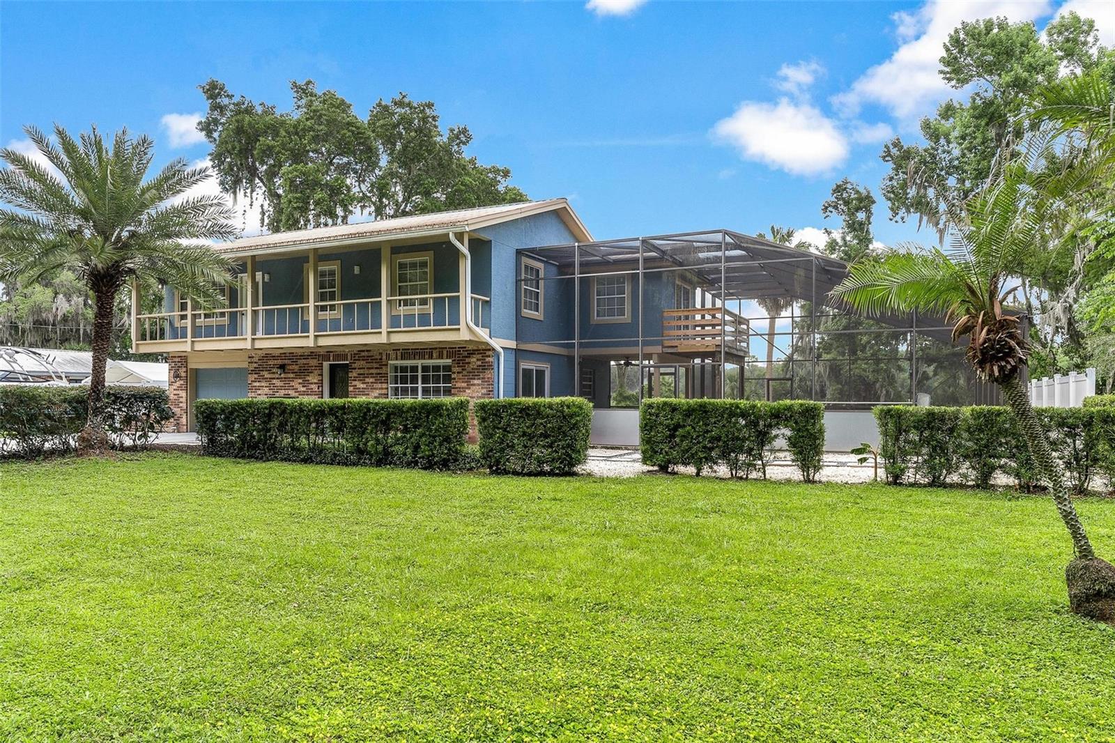 Completely remodeled Chain of lakes Canal Front pool home! Leading directly to Lake Harris and the renowned Harris Chain of Lakes, be sure to bring those fishing poles and your boat! This beautifully updated two-story home offers the perfect blend of modern upgrades and comfortable living space. From the moment you step inside, you’ll appreciate the extensive renovations completed throughout the home including luxury vinyl plank flooring, crown molding, updated lighting and ceiling fans, and a fully remodeled interior from top to bottom.
The stunning kitchen has been completely redesigned and features quartz countertops, top-of-the-line LG stainless steel appliances, a stainless farmhouse sink, and an impressive walk-in butler’s pantry complete with electric outlets for coffee makers and additional kitchen appliances. There is a lovely downstairs living room and an additional Family room upstairs complete with a custom accent wall, electric fireplace, and built in TV. Downstairs, the living room leads out to the screened pool and patio area, creating an ideal setup for entertaining. The oversized screened pool area is inviting and private, and the pool has recently been resurfaced. The backyard is fully fenced and overlooks the canal. There is also a 30-amp plug already in place for an RV or electric vehicle charging. Conveniently located downstairs is a beautifully updated half bath for guests. Upstairs you’ll find spacious guest bedrooms and a fully remodeled guest bathroom showcasing beautiful tile work, updated fixtures, and modern finishes. One of the guest bedrooms even offers its own private balcony with water views. The spacious primary suite easily accommodates a king-sized bed with additional room for a sitting area and features private balcony access overlooking the pool. The luxurious primary bath has been completely remodeled with dual sinks, a soaking tub, and separate shower. Additional upgrades include a new air conditioning system with Nest remote access capability and a new water heater. Located just minutes from Venetian Gardens, downtown Leesburg, restaurants, shopping, medical facilities, boat ramps, and waterfront attractions including ski beach, this is a rare opportunity to own a move-in ready waterfront home on the Chain of Lakes.