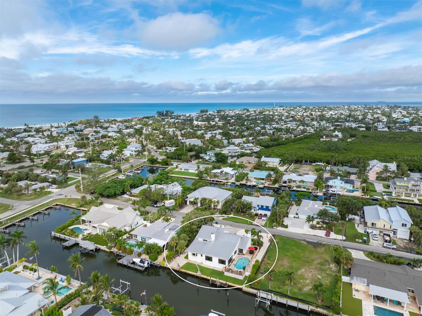 Discover paradise at this stunning canal front retreat that includes 5 bedrooms and 3.5-bathrooms.  Located in the heart of Holmes Beach just a short stroll to the Gulf Beaches, restaurants, shops and more!  This renovated gem offers modern elegance situated on a serene canal with direct access to Tampa Bay, ideal for boat lovers!  Step inside to an open-concept living space, featuring Brazilian walnut floors, fireplace and natural light that shines through the impact hurricane windows and doors.  Enjoy the gourmet kitchen, complete with custom cabinetry, sleek stainless steel appliances, marble countertops and more!  The master suite is conveniently located on the main level with a walk in closet and a fireplace. It is a private oasis, boasting a spa-inspired ensuite with dual vanities and a walk-in shower. Four additional bedrooms provide ample space for family, guests, or a home office/gym.   Outside, your tropical haven awaits. Dive into the sparkling pool, relax on the expansive deck, or take your boat straight from your private dock to explore the open waters. With lush landscaping and breathtaking canal views, this backyard is perfect for sunset gatherings or quiet mornings with coffee in hand.  Located just steps from the pristine beaches of Anna Maria Island, this home offers the ultimate Florida lifestyle.  This home has been lovingly  enjoyed and very well taken care of by the full time owners.  Schedule your private tour today!