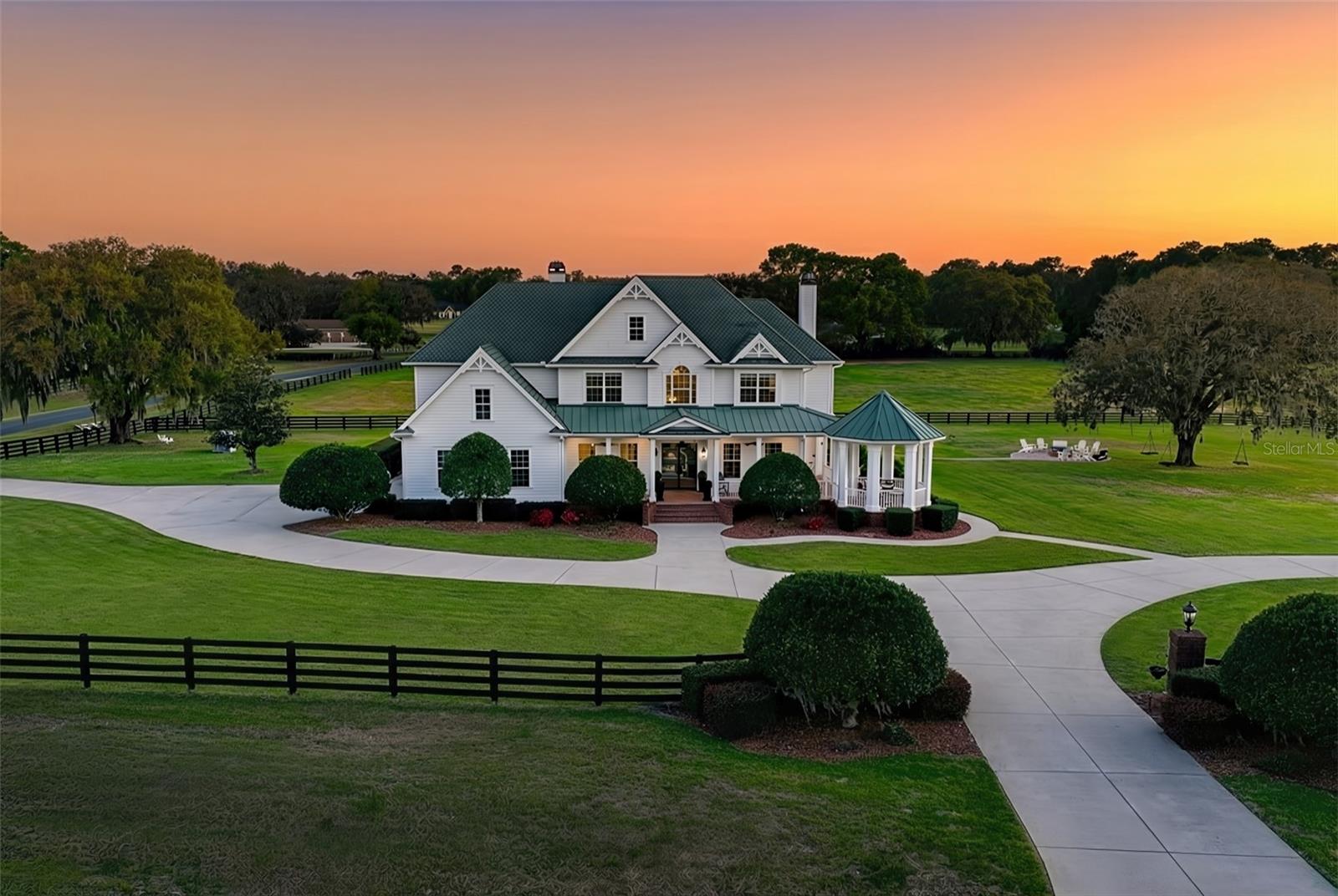 One or more photo(s) has been virtually staged. Only interior Barn pic is virtual. Exquisitely renovated and set on nearly 14 acres on 2 contiguous parcels in the highly desirable Greenway Crossing community, this exceptional estate delivers the rare combination of timeless Southern architecture, modern luxury finishes, and true estate-scale living—just minutes from the Santos Trail system and the heart of Ocala’s premier horse country.

Greeted by custom iron Milano doors on the southern charm front porch, the home has been completely reimagined with a designer’s eye with flooring throughout showcases a curated blend of Thassos & Nero Marquina marble, French limestone, and stunning Herringbone White Oak, creating a layered, high-end aesthetic that is both bold and timeless. The layout of the home surrounded in wrap around porches is perfect for families and entertaining with multiple spaces to enjoy watching movies, eating and or lounging. 

The kitchen is a true showpiece—designed for both entertaining and everyday luxury—featuring all brand new gunmetal DACOR appliances including a double sub fridge, two ovens, 4 burner gas cooktop with griddle, an ultra lux wine dispenser, elite cabinetry, quartz countertops, gold fixtures / lighting and a custom butcher block island that anchors the space with warmth and functionality overlooking the sparkling pool.

Additional upgrades include Lutron smart lighting controls, integrated LED lighting, HEOS whole-home audio system, custom Milano iron doors, Buster & Punch hardware, and designer Graham & Brown wallpaper accents. 

Outdoor living is equally impressive, with a screened pool and spa equipped with Pentair ScreenLogic controls, expansive brick paver entertaining areas, and covered spaces designed to capture the peaceful views of the surrounding acreage. 50 year Carriage House Roof!

The property is fully fenced with classic black board fencing and adorned with mature oak trees, offering open pasture and a detached oversized Kentucky style barn currently set up as a gym with full Bath and 1500 Sq. ft. second story that could be finished with versatile use including a very simple transition to a European 6 stall Stables or recreational use.

Whether you're hosting under the oaks, enjoying quiet mornings on the wraparound porch, or entertaining poolside as the sun sets over the pasture—this property doesn’t just check boxes… it creates moments and a lifestyle that’s getting harder to find and impossible to recreate at this level. The sunsets are INCREDIBLE!