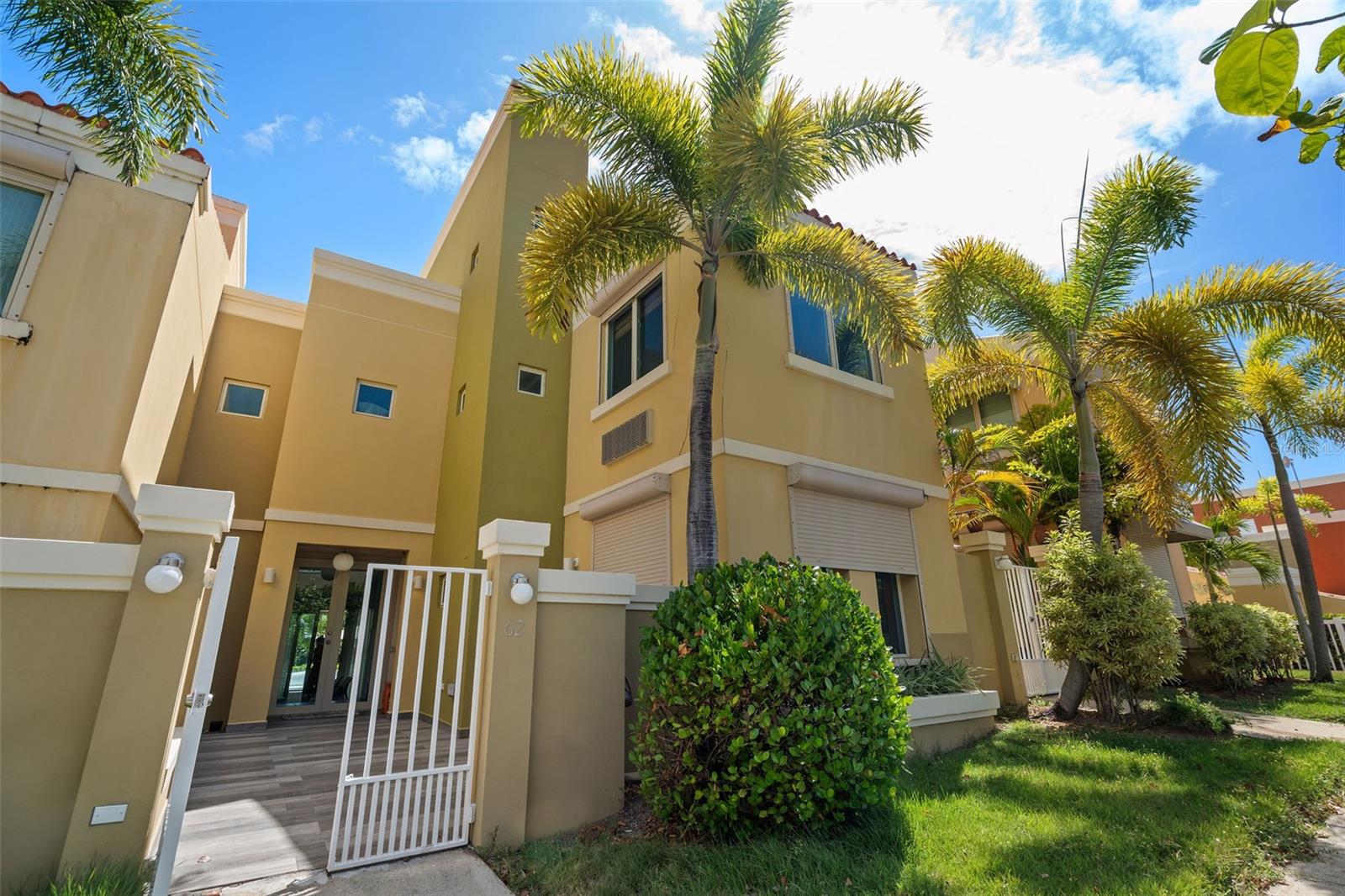 Welcome home to Unit 62 at Aquabella, a three-bedroom, three-bathroom townhouse located within the gated Aquabella community in the heart of Palmas Del Mar, Humacao. With 2,200 square feet of living space spread across three levels, this residence offers the space and flexibility your lifestyle deserves.

Imagine waking up each morning to resort views that remind you that you live somewhere truly special. The three-level layout creates natural spaces for living, working, and entertaining, with mini-split air conditioning throughout the home to keep every corner cool and comfortable under the Puerto Rico sun. The kitchen and living areas flow together naturally, making this home as practical as it is inviting.

The primary bedroom features a private en-suite bathroom, offering a peaceful personal retreat at the end of the day. The other two bedrooms share a Jack and Jill bathroom, ideal for children, guests, or a home office, and a full bathroom in the living area adds extra comfort and flexibility for everyday living and entertaining.

The interior laundry area adds everyday convenience, and the property features electric storm shutters throughout, offering peace of mind and protection during hurricane season.

Step out onto your covered terrace with awnings in the backyard, the perfect spot to enjoy your morning coffee, host friends for dinner, or simply unwind as the tropical breeze rolls in. The backyard patio is finished in pavers, ideal for enjoying the outdoors with comfort and low maintenance.

Two open parking spaces plus a dedicated golf cart space make getting around Palmas Del Mar easy. Aquabella residents enjoy access to a community pool within a secure, gated setting.

Beyond your front door, Palmas Del Mar offers two golf courses, a tennis club, an equestrian club, a beach club, the private bilingual Palmas Academy school, and two marinas- everything you need to live the resort lifestyle every day.

Furniture is negotiable. The Aquabella fee is $375 per month. The Palmas Del Mar community annual fee is $1,300.