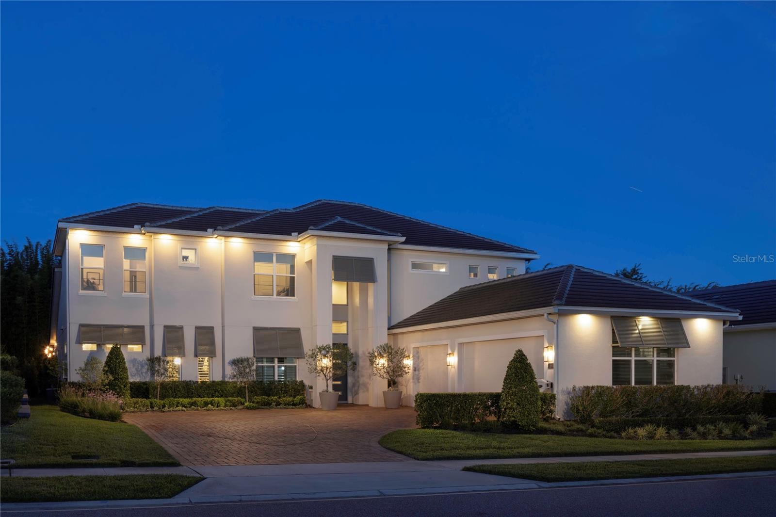 Lavishly designed for modern living and exceptional entertaining, this newer-built residence within the gated community of Sylvan Trails offers nearly 4,200 square feet of refined living space, featuring four bedrooms, 3.5 baths and a seamless blend of elevated design, contemporary comfort and effortless indoor-outdoor living. From the moment of entry, the home showcases a designer-inspired aesthetic defined by intricate architectural details, curated lighting selections, and thoughtfully appointed finishes throughout. Wood flooring extends across the main living spaces, creating warmth and continuity while complementing the home's clean, modern design. Filled with natural light, the open-concept layout is centered around expansive gathering areas that flow effortlessly between the kitchen, dining, and living spaces, creating an inviting atmosphere equally suited for intimate evenings and large-scale entertaining. At the heart of the home, the chef's kitchen combines style and functionality with an impressive suite of Viking appliances, generous preparation space and seamless connection to the surrounding living areas. Adjacent to the kitchen, a dedicated entertaining space features a striking wine display wall and bar area, providing a distinguished focal point for hosting guests and creating memorable gatherings. Designed to accommodate everyday living and long-term convenience, the thoughtfully planned floor plan includes four spacious bedrooms, three-and-a-half baths and the rare advantage of dual laundry rooms, with one on each floor. This practical feature enhances functionality while supporting the flexibility and ease expected in a home of this caliber. Outdoor living is equally compelling. Surrounded by mature landscaping that creates a private and tranquil setting, the backyard has been designed as an extension of the home. An expansive resort-style pool and spa serve as the centerpiece of the outdoor environment, complemented by a fully equipped summer kitchen, inviting fire pit, and multiple spaces for dining, relaxation and entertaining. Artificial turf enhances the beauty and usability of the backyard while providing a low-maintenance setting for year-round enjoyment. Combining modern architecture, designer finishes, and thoughtfully curated indoor and outdoor living spaces, this exceptional Sylvan Trails residence presents a rare opportunity to enjoy a refined lifestyle within one of Seminole County's desirable gated communities, conveniently near Central Florida's premier dining, shopping, business centers and transportation corridors.