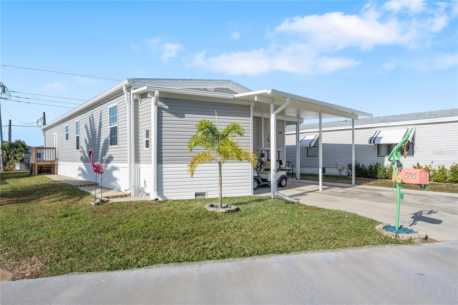 This like-new 2024 Champion manufactured home offers 3 bedrooms, 2 baths, and 1,485 sq ft of comfortable living space in Harbor Cove, a desirable 55+ waterfront community along the Myakka River. As a newer home, it provides the confidence of modern construction and Energy Star–certified efficiency, giving buyers peace of mind and reduced maintenance concerns. Per Sarasota County, flood insurance is not currently required on this elevated home. Three-bedroom homes are rare here, and this one features an open floor plan, a neutral color palette, and untouched walls that provide a clean blank slate for your personal style. The spacious living room is open to the dining area and kitchen which features stainless steel appliances and center island for prepping and more eating space, a separate interior laundry room houses a full size washer, dryer, and freezer, the large primary bedroom suite has a walk in closet and ensuite bath and two additional bedrooms, each with walk in closets, are near the hall bathroom. Outside find more storage space in the shed under the carport. The home is being sold furnished and includes a golf cart for easy exploring, where you’ll enjoy tropical landscaping and frequent wildlife sightings along the way. With low HOA fees of $175 per month, residents enjoy access to fantastic amenities, including a two-story clubhouse overlooking the marina, two swimming pools, a spa, various sports courts such as pickleball and shuffleboard, a fitness center, craft rooms, and an optional woodworking shop. Harbor Cove also has Gulf access via the river, with boat slip rentals available for only $300 per year. The community is known for its vibrant social calendar offering dances, holiday parties, picnics, card games, entertainment shows, and countless other activities that make it easy to stay active and connected. Conveniently located near shopping, Costco, restaurants, spring training baseball, and beautiful Gulf beaches, this home blends modern reliability, efficiency, and an active Florida lifestyle. Schedule a private tour today!