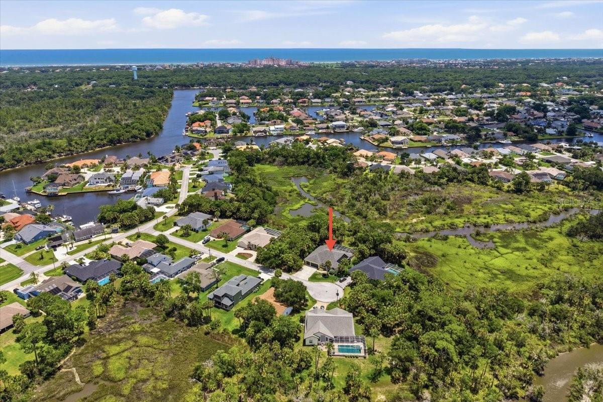 Located on the Nature Reserve Conservation area! AMAZING PRIVACY! 3 Car garage for all your toys! Tucked away at the end of a quiet cul-de-sac, this stunning pool and Spa home offers the perfect blend of luxury, privacy, and breathtaking natural beauty with peaceful saltwater marsh views right from your backyard. From the moment you walk in, soaring vaulted ceilings and an open, light-filled floor plan create an impressive yet welcoming feel. The spacious living area centers around a spectacular tiled fireplace, while the oversized kitchen is truly the heart of the home featuring a massive island, abundant cabinetry, and seamless flow into the breakfast nook and family room, making it ideal for entertaining.  The private Primary Suite is a true retreat with a sunny sitting area, elegant coffered ceilings, and sliders that open directly to the sparkling pool.  The pool and spa were resurfaced in April 2026. The luxurious Primary Bath features a jetted garden tub, double vanities, oversized walk-in shower, and large walk-in closet. Guests will enjoy two spacious bedrooms and a full bath that conveniently doubles as a pool bath.    Step outside and fall in love with your own private paradise. The oversized screened lanai overlooks the serene saltwater marsh with no rear neighbors, creating total privacy and peaceful nature views from nearly every angle. Whether you’re hosting gatherings, grilling, relaxing poolside, or simply enjoying the coastal breezes, this outdoor space was designed for the ultimate Florida lifestyle. Additional features include a formal dining room, separate laundry room, and an oversized 25-foot-deep 3-car garage complete with utility sink, screen door, and planked attic storage.   Major updates have already been completed for peace of mind including roof replaced in 2018, windows updated in August 2020, doors replaced in 2020, water heater 2018, Newer LVP FLooring (NO CARPET)  Trane XL AC UNIT, POOL Resurfaced 2026, Screen enclosure reinforced with new panels 2026, New bathroom cabinets and more! MOVE IN AND LIVE THE ULTIMATE SALT LIFE!  Homes offering this kind of privacy, pool lifestyle, and marshfront setting rarely come available — don’t miss this incredible opportunity!