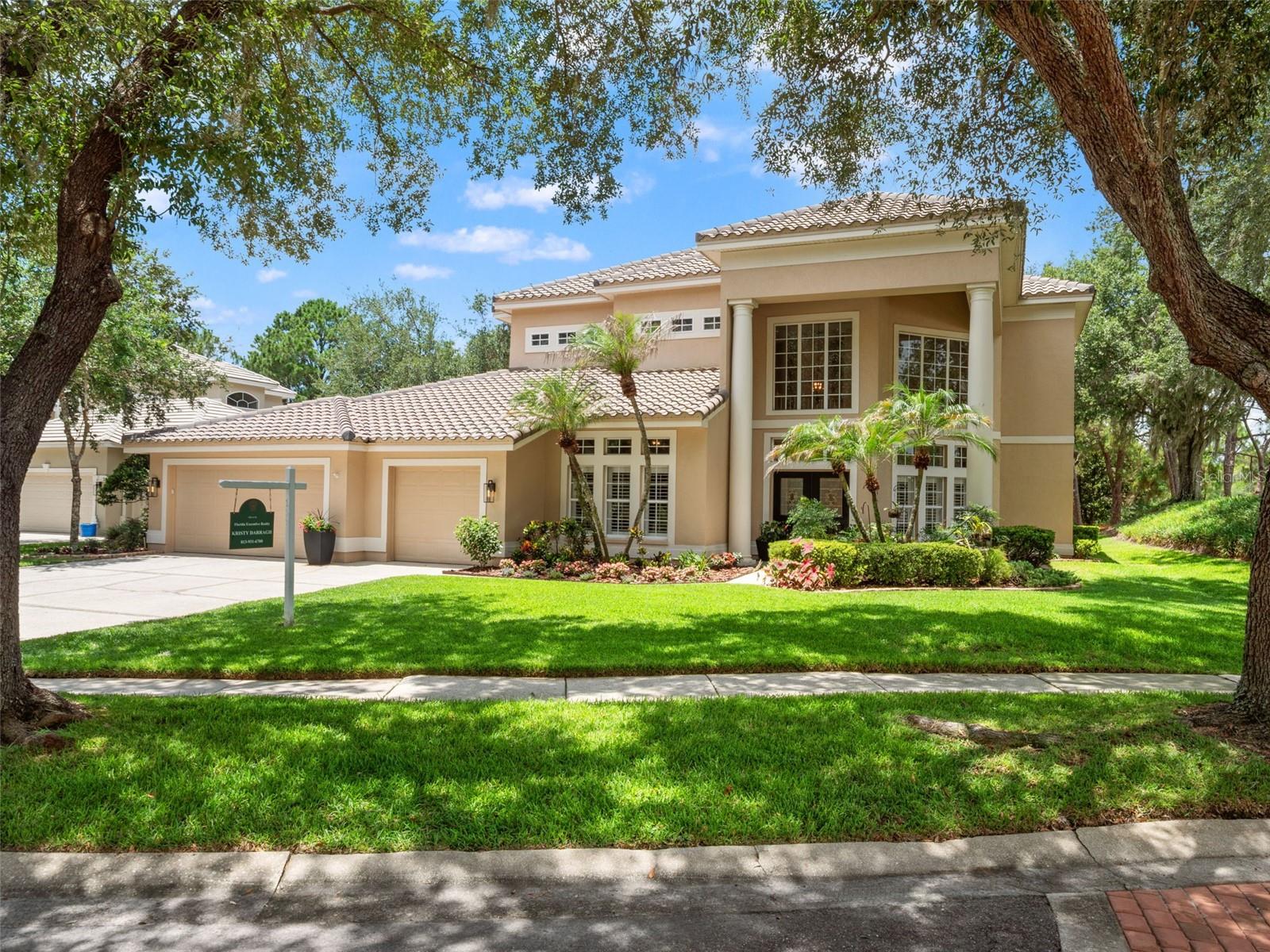 Resort living at its best! Perfectly positioned on a sprawling golf course homesite with no front or rear neighbors, this exciting new listing offers the privacy, elegance, and lifestyle buyers dream about. Custom built by Hannah Bartoletta Homes and located in the prestigious guard-gated community of Hunter’s Green, this is the home you’ll want to call your own.

This desirable floor plan features the primary suite and office downstairs, with the office offering flexibility as a potential 5th bedroom, plus three additional bedrooms and two full baths upstairs for the perfect blend of convenience and privacy. The curb appeal is dramatic from the moment you arrive, with soaring two-story column accents and beautifully manicured gardens creating an impressive first impression.

Step inside and you immediately know this home is different. The interior feels open, grand, and filled with natural light, with soaring two-story ceilings throughout many of the main living areas. The formal living room makes a beautiful statement with custom plant shelves, crown molding, expansive windows, and plantation shutters. It flows seamlessly into the generous formal dining room, featuring cherry plank hardwood floors and lovely views of the landscaped gardens.

The family room is truly the showstopper, highlighted by a soaring two-story display wall accented with multiple windows. You'll love the three oversized sliding glass doors that pocket into the wall, perfectly framing soothing views of the pool, spa, and golf course beyond. The chef’s kitchen is spacious and functional, offering 42-inch raised-panel maple cabinetry, sleek Corian countertops, newer stainless steel appliances, and a smart wraparound design that provides exceptional counter space and storage. Just off the kitchen is a full pool bath with a newer quartz countertop and walk-in shower.

The downstairs primary suite is a private retreat, complete with double French doors that open directly to the pool area and showcase scenic golf course views. It is the perfect place to wake up to peaceful fairway vistas and end the day with that true resort-at-home feeling.

The open staircase leads to three private upstairs bedrooms and two full baths, creating an ideal layout for family, guests, or flexible living needs. The crown jewel of the home is the expanded outdoor living area, featuring elegant stone pavers, a separate covered sitting area, sparkling salt-system pool, and soothing heated spa. Enjoy cool summer breezes while overlooking the 5th hole of the Tom Fazio-designed championship golf course, a peaceful backdrop that makes every day feel like a vacation.

Located in one of New Tampa’s most desirable guard-gated communities, Hunter’s Green offers an exceptional lifestyle with mature landscaping, parks, playgrounds, walking trails, tennis courts, sports fields, and easy access to top-rated schools, shopping, dining, USF, Moffitt, AdventHealth, and major highways. Welcome Home!