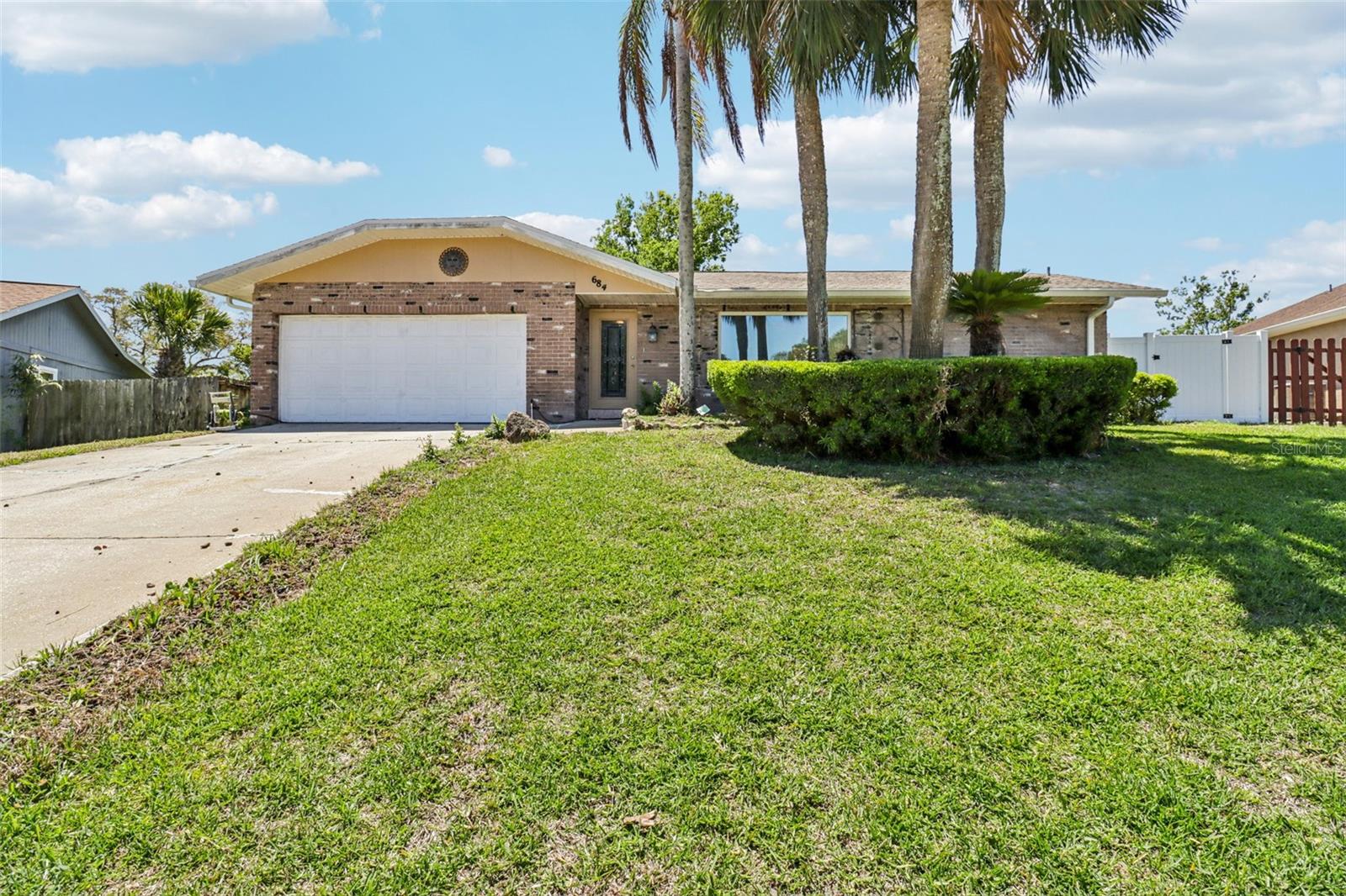This 3-bedroom, 2-bath home offers a functional layout with tile and vinyl flooring throughout, providing both durability and style. The kitchen flows into the main living space, creating a comfortable setting for everyday living, and a fireplace in family room. A bright Florida room adds extra living space, perfect for relaxing, entertaining, or a home office. Step outside to a spacious yard with plenty of room for outdoor activities, plus a shed with electricity for storage, workshop use, or hobbies. Conveniently located near schools, shopping, dining, and just a short drive to the beach.