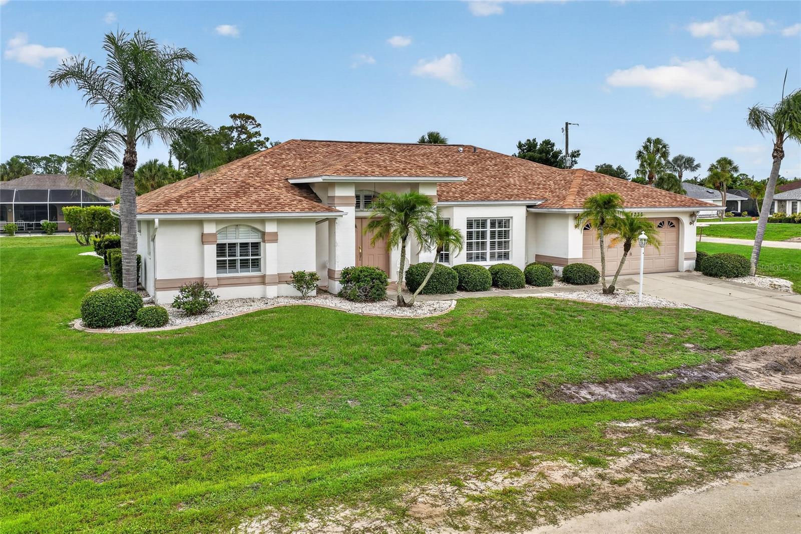 SPACIOUS POOL HOME ON OVER HALF AN ACRE WITH NO HOA! Welcome to this beautifully maintained 3 BEDROOM, 2.5 BATHROOM POOL HOME situated on a generous 0.53-ACRE CORNER LOT in the heart of Port Charlotte. Offering an impressive combination of space, privacy, and functionality, this property provides the perfect setting for both everyday living and entertaining.

From the moment you step inside, you'll appreciate the soaring vaulted ceilings and bright, open living spaces that create an inviting and airy atmosphere throughout the home. The thoughtfully designed floor plan offers plenty of room to spread out, while large windows and sliding glass doors allow natural light to pour in.

The oversized kitchen is a true centerpiece of the home, featuring abundant cabinetry, ample counter space, and room for multiple cooks to gather comfortably. Whether you're preparing meals for family or hosting friends, this kitchen is designed to handle it all with ease.

Retreat to the spacious primary suite, complete with private sliding glass door access to the pool area and an oversized ensuite bathroom. The primary bath features a relaxing jetted soaking tub, separate walk-in shower, and plenty of space to create your own private spa-like retreat.

Step outside and discover your own backyard oasis. The screened pool area offers the perfect place to cool off on warm Florida days, while the expansive outdoor entertaining space is ideal for gatherings of any size. The outdoor patio includes a convenient entertaining area with cabinetry, sink, bar seating, and plenty of room for outdoor dining and relaxation, making it easy to enjoy Florida living year-round.

This home also offers valuable updates for peace of mind, including a new roof installed approximately 4 years ago, new pool pump approximately 4 years ago, new pool heater approximately 5 years ago, and a new water heater installed in 2022. Additionally, the property is now connected to city sewer, eliminating the need for a septic system.

With NO HOA FEES, a rare half-acre-plus corner lot, and a location convenient to shopping, dining, golf, boating, beaches, and all that Southwest Florida has to offer, this home presents an outstanding opportunity to enjoy the Florida lifestyle you've been dreaming of.

Don't miss your chance to own this spacious pool home with room to live, entertain, and enjoy everything Port Charlotte has to offer!