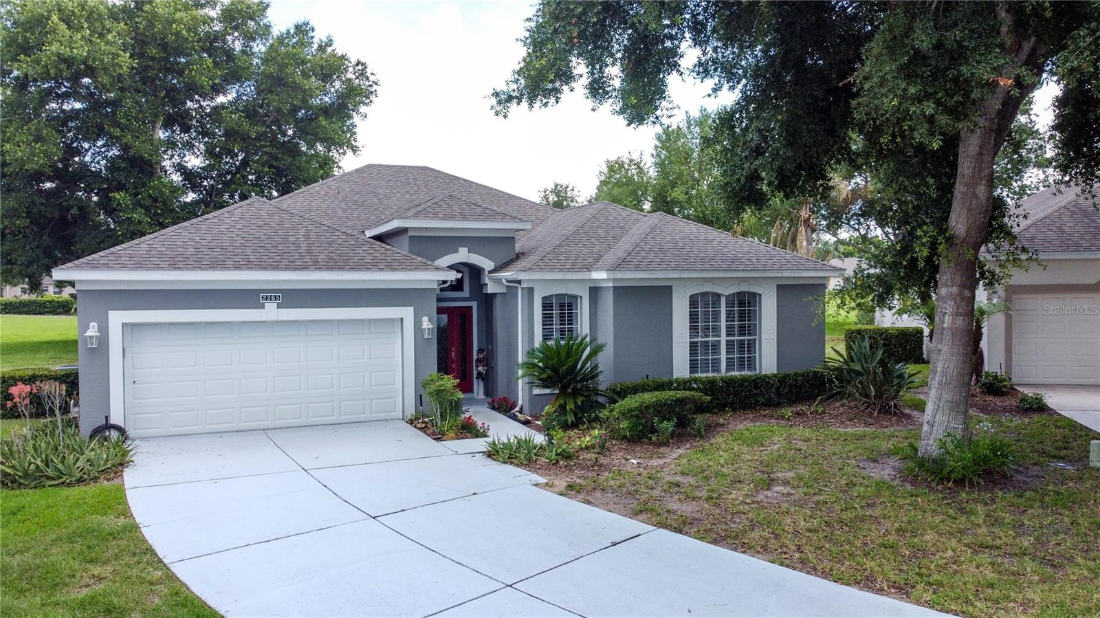 Welcome to 55+ Kings Ridge! This rare St James model is located in a quiet cul de sac and has fantastic views over the golf course. You must come and view the  extra large back screen enclosure where you can enjoy the great views of the golf course. This makes for a party waiting to happen!  The Gazebo remains along with the patio furniture in the back. The front entry has tile and a beautiful leaded glass door. The great room, primary bedroom and den/3rd bedroom have wood flooring. The kitchen & dinette area have ceramic tile. The kitchen has real wood cabinetry, Corian countertops, and beautiful stainless appliances. The dinette area has additional cabinetry that matches the kitchen cabinets for plenty of storage. Very open plan with a very large great room with views out to the golf course. The roof was replaced in Oct 2021. 3 windows were replaced in Dec of 2021.  The primary bathroom has been completely remodeled. The tub was removed and a large dual vanity installed. The shower has no step down and is very accessible. There is also a large linen closet. The primary bedroom has 2 walk in closets. The den/3rd bedroom has a built in murphy bed that will remain. There is a separate laundry room and the washer & dryer remain. There is also a covered lanai that has vinyl doors that open. The gutters on the home have Leaf Filter on them.  Kings Ridge is a 55 Plus gated golf community located in the rolling hills of Clermont, FL. Enjoy the Royal life style in the multi-million $ clubhouse with 3 heated pools, spas, tennis & pickle ball courts, billiards, shuffle board, shows, Bingo, cards and clubs galore. The monthly maintenance fees include: lawn maintenance including trimming of shrubs, care of irrigation system & irrigation water, internet, TV & home phone thru Fibernow, maintenance of roads and outside painting of home every 7-8 years. Take your golf cart to the Kings Ridge Plaza where you can do your grocery shopping, banking or dine out. Approximately 30 minutes to Disney Parks or Universal Studios.