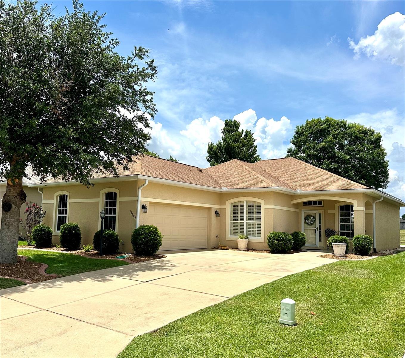 Experience the best of Florida living in this nicely updated Golf Course Front home perfectly positioned on the 8th Fairway with beautiful curb appeal. Located in STONECREST, a 55+ gated community just a short golf cart ride to The Villages! This residence offers effortless access to dining, shopping, entertainment, and recreation while maintaining the privacy and tranquility of an exclusive golf course setting. This Kingsley Model was designed for both entertaining and everyday comfort and has been recently updated with luxury laminate flooring 2026, Epoxy-coated Garage Floor and Paint 2026, ROOF 2022, SOLAR EDGE HOME Solar System 2022 for energy efficiency, Florida Room, Stainless Steel Appliances, Corian Solid Surface Counters, Elegant Crown Molding and much more! Upon entering you'll be impressed with the spacious open concept design, abundance of natural light, 10ft soaring ceilings with sweeping golf course views. The Florida room provides a seamless extension of additional living space creating the perfect setting to enjoy your morning coffee, sunset cocktails or year around entertaining.  The oversized Primary Bedroom suite features a expansive walk-in closet and spa-inspired en-suite complete with a luxurious soaking tub, separate walk-in tiled shower, and a private water closet. The split 2 bedroom design and 3rd bonus room/bedroom/den with closet located in hall make your guests feel at home with their private bath. Stonecrest is a 55 + community with a all the amenities, tennis, pickleball, softball, 3 outdoor swimming pools, one indoor pool, fitness center, 90 different groups and clubs, 18 hole championship golf course, Broad Stripes Restaurant and Social Club, and gated community with a higher level of security with NO BONDS, NO ANNUAL FEES and LOW monthly association fee of only $152!