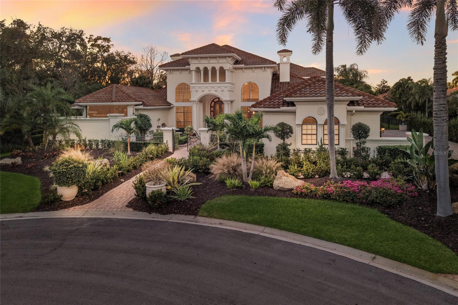 Superior custom offering built by Anchor and inspired by acclaimed designer Marc-Michaels, this impressive residence is privately positioned on .69 acre at the end of a cul-de-sac in Palmers Creek enclave in The Country Club of Lakewood Ranch. Stunning 6,376 square feet of architectural excellence showcasing generously-proportioned spaces, exceptional design, and, IMPACT windows and doors throughout.   Beyond the gated courtyard and mahogany entry door are grand living areas with 23’+ coffered ceilings with double crown molding, oversized windows, floor-to-ceiling limestone and marble cast mantle and hearth gas fireplace, sitting/piano room, elegant formal dining, and a refined wet bar drenched in a wall of wood paneling. Meanwhile the incredibly sized lanai boasts multi-level heated pool and spa, open and undercover travertine decking, outdoor kitchen with 2026 DCS grill, gas fireplace, 2-story lanai cage, pecky cypress ceilings, and oversized fenced back yard. Seamlessly connected to the serene outdoors via impact French doors and sliders is an invitingly large great room open to the kitchen where form and function reigns cohesively with custom limestone and marble cast hood, sprawling granite counters, wood cabinetry by Woodmode, 3 Fisher Paykel ovens, warming drawer, new Miele dishwasher, Subzero refrigerator, secondary prep sink, large island with storage, an oversized hidden walk-in pantry, and large breakfast nook area adorned with the lush preserve views. Unwind in the elegant owner’s retreat on a private wing offering beautifully detailed moldings, 2 walk-in customized closets, direct lanai access, and a luxuriously appointed spa-like bath with Rojo Elegante marble counters, dual entry walk-in shower with multiple shower heads, bench seating, limestone & marble mosaic tile flooring, aquarium window overlooking private garden, double vanity and makeup station with abundant storage, oversized soaking tub, and separate water closet with bidet and pedestal sink. Family and overnight visitors will be right at home with 3 generously sized guest suites all with wood flooring, two on the main level with private full baths accentuated with Italian marble, while on the upper level is the fourth generously sized guest suite with walk-in closet anddirect veranda access. Additionally, upstairs is a large media club room with wet bar, built-in wood cabinetry, wood-paneled entry door, veranda and full bath. Other notable highlights of this all-encompassing 8,537 sf residence includes a private Office on the main level with built-ins, oversized Powder Room and Pool Bath both adorned with marble counters and flooring, Laundry Room with sink, cabinetry and 2022 washer/dryer, secondary desk and drop area off garage entry, 2022 water heater, water softener, solid interior doors, central vacuum, additional batting insulation to interior walls, multi-zoned heating and cooling system with 4 AC units ages 2022-2024, landscape lighting,  side load 3 car garage with a storage, electric charger, and portable generator with dedicated electrical line, and so much more. This one-of-a-kind masterpiece is a testament to refined living for even the most discriminating buyer ideally located within Lakewood Ranch known for its vibrant lifestyle near dining, shopping, polo, golf, tennis, events and entertainment near Waterside, Centerpointe, UTC area, the beaches of Sarasota, and of course, in an A-rated school district next to ODA and a few miles from IMG.