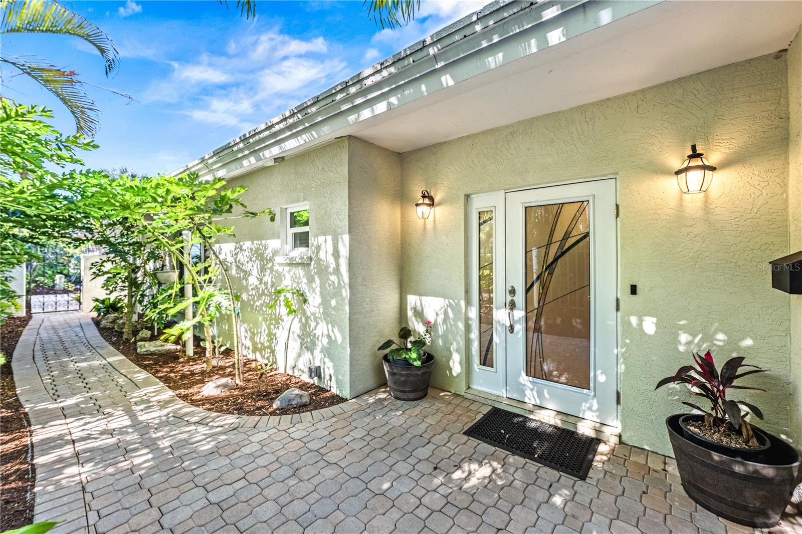 Rarely available direct bayfront 2/2 maintenance free villa in Polynesian Gardens. Magnificent views of the Intracoastal/Little Sarasota Bay. Watch the manatees and boats go by from your paved patio directly on the water. Spacious 2 bedrooms/2 full baths with very large great room. Updated kitchen and baths with new cabinetry, granite and stainless-steel appliances. Plenty of closet space. Garage with plenty of storage plus an extra driveway allows for 2 parking spaces. Newer washer/dryer in garage. Beautiful landscaping. Community has a heated pool, clubhouse and fishing pier. Close to shops, dining and America's #1 Beach - Siesta Key. Free trolley stops directly in the front of the community on Midnight Pass Road. Two pets allowed any size.