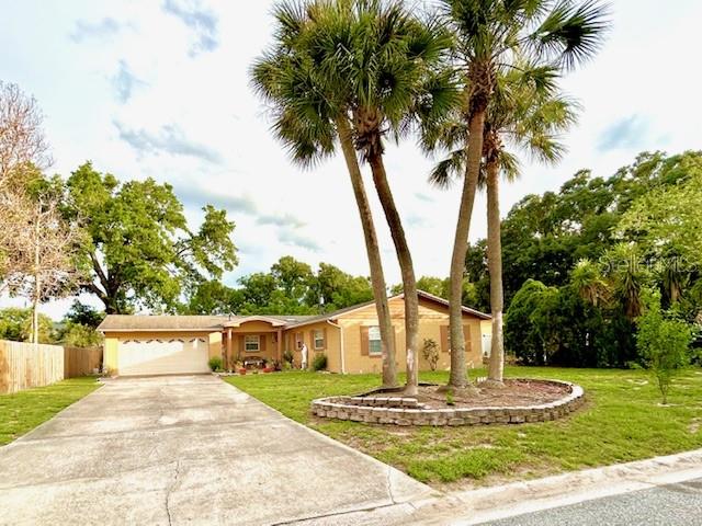 Terrific home in the heart of Altamonte Springs with NO HOA to pay!  As you drive up, capture the beautifully maintained palm trees that stand tall and majestic. Make your way up the oversized driveway and take notice of the tiled front porch area creating an inviting scene to just sit and relax. Upon walking through the front door, this home welcomes you in with an open floor plan and guides you through a well thought out set up.  Take notice immediately of the kitchen Island that creates that perfect spot for pleasant conversations and hearty meals.  Picture yourself hanging out in the family room by the elegant wood burning fireplace on those cold chilly nights waiting for the holidays to come.  Breeze around the kitchen island into the dining/living room area great for entertaining; come around and walk down the hallway to 3 spacious bedrooms and 2 large bathrooms.  Spend your weekends in the large screened enclosed porch, another great area for entertaining.  Backyard is perfect for intimate barbecues.  Roof replaced in 2023.  Exterior A/C condenser unit newer. If a great location is what you are looking for that is near major shopping, restaurants, hospital, clinics, highways and entertainment, then don't pass this house by without scheduling a viewing. Call for an appointment today!