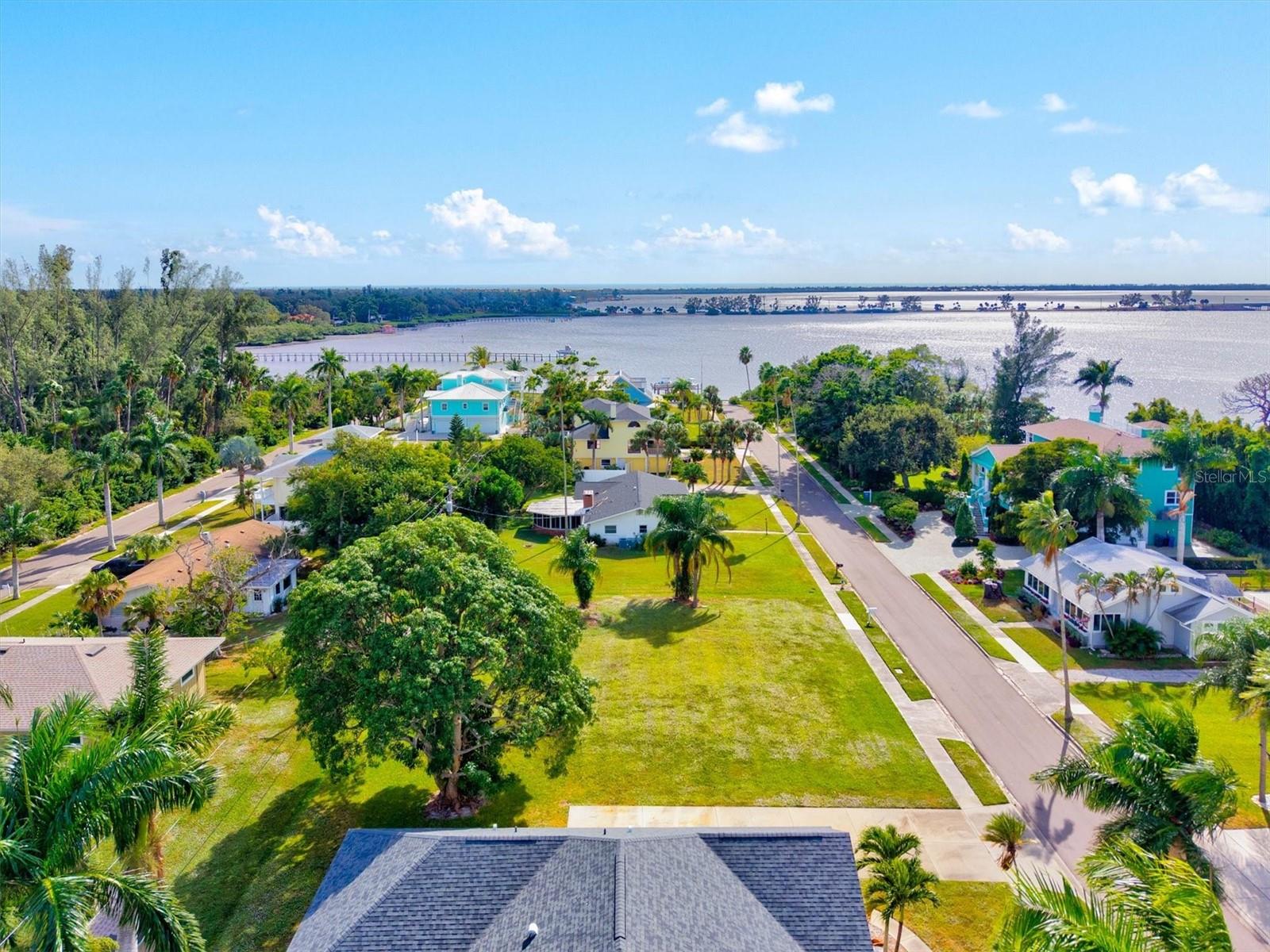 An exceptional opportunity awaits to build your dream home at Bayview Grove, a beautifully cleared and well-maintained double lot offering approximately .25 acres of prime land in one of Northwest Bradenton’s most desirable areas. With a 25-foot setback and the homesite sitting approximately 7 feet above sea level, this property offers excellent flexibility for a custom build and may allow for potential water views, depending on home design and elevation. Utilities are already available at the lot, as a previous home once stood on the property—saving time, effort, and expense as you move forward with construction. Enjoy the freedom of no HOA or CDD fees, and plenty of room to design the home you’ve always envisioned. Take a short stroll up the street to watch breathtaking sunsets over Palma Sola Bay, or grab your fishing pole and enjoy great local fishing nearby. Outdoor enthusiasts will love the close proximity to Robinson Preserve, known for its scenic trails, kayaking, and natural coastal beauty. Ideally located just minutes from Anna Maria Island, Bradenton Beach, and the historic fishing village of Cortez, Bayview Grove offers the perfect blend of relaxed coastal living and everyday convenience. Vacant land opportunities like this in Northwest Bradenton are rare—don’t miss your chance to create a custom home near the bay and beaches.