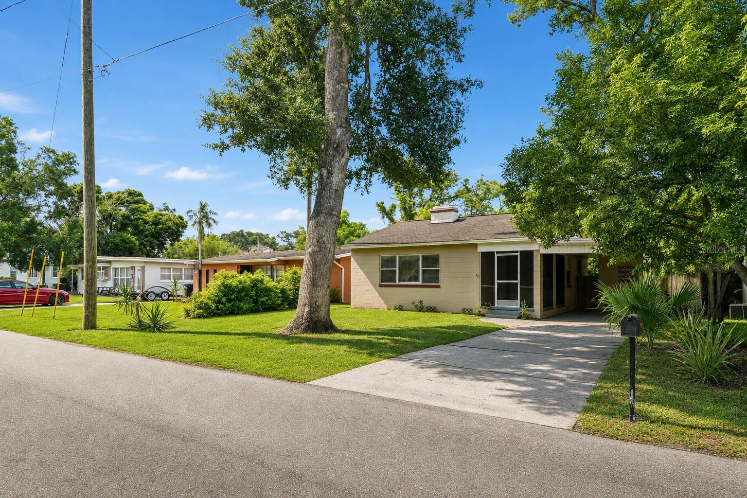 Roof 2018 | HVAC 2020| Set on a deep, tree-canopied lot in one of Winter Park's most desirable established neighborhoods, this charming single-story concrete-block home blends timeless character with everyday convenience. A grand oak shades the front lawn, helping cool the home and lower energy costs, while durable masonry construction, a dimensional-shingle roof, and a full-length driveway leading to a covered carport deliver lasting value and practical, protected parking with an attached workshop & storage room. A generous screened front porch offers a breezy, bug-free spot for morning coffee or evening relaxation before you step inside to a spacious living room featuring gleaming refinished hardwood floors and a wood-burning fireplace framed by a classic white mantel with fluted columns. A large picture window floods the room with natural light, and a graceful curved archway, one of the home's most distinctive architectural details, leads you deeper into the thoughtfully connected floor plan.
The kitchen is efficiently designed with cabinetry lining both walls for ample storage, laminate counters, under-cabinet lighting, and a full stainless-steel appliance suite. A double sink offers plenty of room to work and a large window overlooks the lush backyard, with a rear door providing easy access for grilling and entertaining. The adjacent, light-filled dining room offers flexible space that works well for family meals, a home office, or a quiet reading nook. Two comfortable bedrooms feature hardwood floors, ceiling fans with lights, and built-in closets, one with built-in shelving, while the bright corner primary enjoys windows on two walls for excellent light and cross-ventilation. A full bathroom is finished with a tiled tub-and-shower combination, a wood vanity, and a frosted privacy window that brings in daylight while maintaining seclusion. Out back, a large, fully fenced yard framed by mature oaks, palms, and established privacy hedges creates a secluded, park-like retreat with ample room to garden, play, entertain, or add a pool. Just minutes from historic Park Avenue, residents enjoy boutique shopping, award-winning restaurants, sidewalk cafés, museums, and year-round community events, with nearby College Park adding popular dining, breweries, and specialty shops. Outdoor recreation abounds with Dubsdread Golf Course, Mead Botanical Garden, Kraft Azalea Garden, and numerous parks close by, plus easy access to Winter Park's scenic chain of lakes and walking trails, all without requiring waterfront ownership.
Commuting is effortless thanks to convenient access to Interstate 4, Fairbanks Avenue, Lee Road, SR 426, and SR 436, providing quick connections throughout Central Florida. Downtown Orlando, the Orlando Health and AdventHealth medical campuses, and major employment centers are all within easy reach. With excellent shopping, grocery stores, entertainment, and cultural attractions nearby, this sought-after location offers the perfect balance of quiet residential living and close proximity to everything Central Florida has to offer. This listing is for a single home and lot at 846 Driver Ave, but the owner would also consider selling the adjacent home next door to the North at 844 Driver Ave. If you are interested in purchasing both homes simultaneously, contact listing agent for more details.