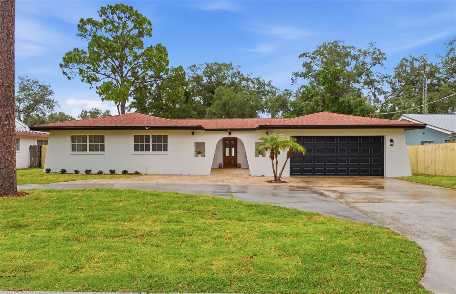 Nestled on a quiet cul-de-sac in the heart of Temple Terrace and set on a sprawling quarter acre lot, 5106 Oakhaven Ln offers the perfect blend of modern design, thoughtful functionality, and Florida outdoor living. Conveniently located just minutes from Downtown Tampa, USF, major hospitals, shopping, and dining, this beautifully reimagined 4-bedroom, 2-bath home checks all the boxes.

Inside , you’ll find an ideal split-bedroom floor plan and an open-concept layout designed for both everyday living and entertaining. The completely remodeled custom kitchen is truly the heart of the home, featuring a stunning oversized island with custom paneling, waterfall-edge quartz countertops, and generous seating for three or more. Additional highlights include abundant cabinetry, and gorgeous countertop-to-ceiling ceramic tile backsplash that creates a clean, timeless look.

From the kitchen, you’ll enjoy uninterrupted views of the spacious dining and living areas before stepping into the bright, airy breezeway. Two brand-new Pella sliding glass doors open to your private backyard retreat, where a beautifully resurfaced in-ground pool and all-new pool equipment are ready for years of enjoyment.

Unlike many homes with pools, this oversized quarter-acre lot still offers plenty of usable yard space. Whether you envision a fire pit, playground, outdoor kitchen, garden, badminton or volleyball court, or simply room to relax, there’s space to make it your own.

With designer finishes, quality upgrades, an incredible layout, and a backyard built for entertaining, this Temple Terrace gem truly has it all.
CALL TODAY FOR YOUR PRIVATE SHOWING!