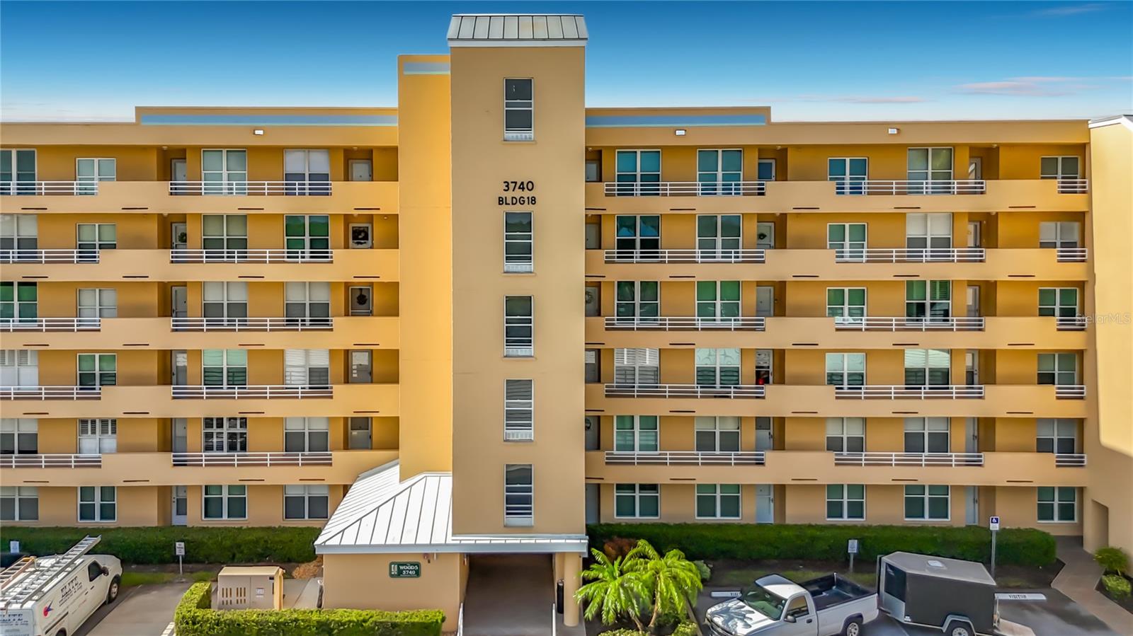 This 6th-floor condo in The Woods at Pinebrook offers panoramic GOLF COURSE AND LAKE VIEWS with the peace of mind of having NO NEIGHBORS ABOVE. The kitchen features elegant white refaced cabinetry, glass-front accents, ample counter space, and a dedicated water filtration system. Unique to this unit are TWO ENCLOSED GLASS AND SCREEN LANAIS—one extending the living area and another creating a private retreat off the primary suite. The spacious primary bedroom also includes a LARGE WALK-IN CLOSET for plenty of storage. Recent updates include a New water heater (April 2026) and AC (2021).  Convenience of an interior laundry room with full-sized washer/dryer and assigned covered carport (#74). The clubhouse and screened enclosed heated pool are located directly across from the condo building.  Enjoy access to a fitness center, billiards, tennis, pickleball, and shuffleboard. Golf enthusiasts will enjoy the optional membership for the Ironwood/Pinebrook course or "pay as you play" flexibility.  Ideally situated near GT Bray Park, Robinson Preserve, and top-tier shopping and dining, this elevator-accessible condo combines maintenance-free living with an active lifestyle that offers no age restrictions and is pet friendly.  Being sold As-Is.