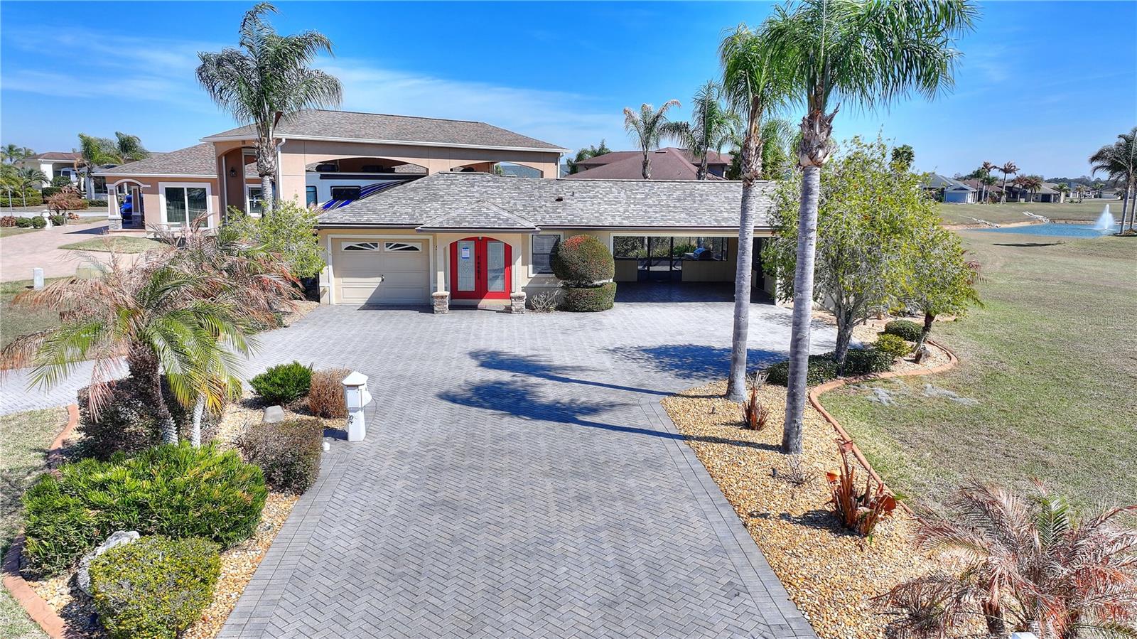 One or more photo(s) has been virtually staged. Are you searching for a winter escape, a place that combines the comforts of a charming casita home with the freedom to embrace the RV lifestyle?  Look no further! This delightful RV casita, nestled in the highly desirable Mt. Olive Shores North community, offers the perfect blend of luxury, convenience, and potential. This charming casita is located on two lots, providing you with unparalleled privacy and ample room for expansion.

Picture yourself in the bright and airy living area, bathed in natural light streaming through the windows, offering a picturesque view of the beautifully landscaped yard. The kitchen, complete with an eat-in area, is perfect for preparing meals. The bedroom features a space-saving Murphy bed and built-in closets, maximizing your living space. And the bonus room? Let your imagination run wild! It could be your home office, a creative workshop, a charming she-shed, or even a second bedroom. Beyond the main living area, you will find a two-car garage with remote-controlled sun screen, along with separate small garage ideal for storage or your golf cart.  
The corner lot boasts ample RV parking in front with full RV hook-ups and a separate driveway, making it a true haven for the RV enthusiast. 

But the magic doesn't stop there. Extend your living space outdoors onto a screened-in lanai, complete with an outdoor grilling/kitchen area. This is the perfect spot for entertaining friends and family, or simply unwinding in the fresh air. The lanai seamlessly flows into a private backyard oasis, offering ultimate tranquility and privacy. Imagine relaxing by the fire pit on the additional patio, overlooking a serene pond.

This casita has been meticulously maintained, boasting numerous recent updates, including a brand-new roof. It's ready for you to move in and start enjoying the Florida sunshine.

This is more than just a casita; it's an opportunity to enjoy the best of both worlds – the comfort of a well-appointed home and the freedom to explore the open road. Don't miss your chance to own this truly exceptional property.

It's a must-see! Schedule your private showing today and prepare to be captivated. We're confident you'll fall in love with this unique blend of comfort and adventure.