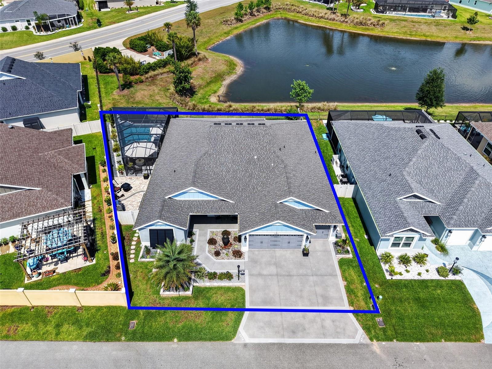 EXQUISITE, PRIVATE, WATERFRONT 4/3 Mason Veranda with SWIMMING POOL, OVERSIZED 28’x27’ TWO-CAR + GOLF CART GARAGE, and 418sf CLIMATE-CONTROLLED GLASS-ENCLOSED LANAI in the VIBRANT Village of DeLuna! Enhanced hardscaping, decoratively painted drive and walkways, Bohemian shutters, and a charming front porch welcome you to this MAGNIFICENT home! Step through a leaded-glass entry into the BRIGHT, GENEROUS foyer. LUXURIOUS PLANK TILE flooring runs seamlessly throughout. UPGRADES include TRIPLE CROWN MOLDING, WINDOW CORNICES, PLANTATION SHUTTERS, and TANKLESS INSTANT HOT WATER HEATER. The STUNNING chef’s kitchen is a true centerpiece, showcasing EBONY SHAKER cabinetry with GLASS-FRONT accents, QUARTZ countertops, ARABESQUE TILE backsplash, KITCHENAID STAINLESS appliances, WINE cooler, GAS cooking, built-in DOUBLE PANTRY, ROLL-OUT shelving, CENTER ISAND, under-cabinet LIGHTING, and EAT-IN breakfast bar adorned with WAINSCOTING. From the main living area, sliding glass doors open to a STUNNING GLASS-ENCLOSED lanai featuring remote-controlled solar shades and TWO ceiling-mounted mini-splits for year-round comfort. Adding an IMPRESSIVE 418sf of LIVING SPACE, this EXTRAORDINARY ROOM is surrounded by WALLS of WINDOWS capturing PANORAMIC WATER VIEWS! Glass doors seamlessly connect the lanai to a screened outdoor area featuring a SALTWATER HEATED SWIMMING POOL with beach entry and waterfall and electric heating. Surrounded by a PRIVACY wall and lush landscaping, this offers a rare sense of seclusion while still showcasing PEACEFUL WATER VIEWS. An adjacent PAVER patio further enhances the outdoor experience, providing the perfect setting for grilling. Returning indoors, the luxurious primary suite boasts a TRIPLE-CROWNED TRAY ceiling and TWO CUSTOM WALK-IN closets. It’s en-suite bath features DUAL vanities with QUARTZ tops, built-in LINEN closet, Roman-style TILE WALK-IN shower, and private water closet. The second and third bedrooms are behind a POCKET door, creating a separate guest wing. Bedroom two offers a VAULTED ceiling and built-in closet. The second bath features an EBONY vanity with QUARTZ top, TILE tub/shower combo, and hall LINEN. The third bedroom has a built-in closet. Bedroom four and the third bath lie in the center of the home providing flexibility for a home office or additional guest quarters. The fourth bedroom has a built-in closet and the third bath offers an EBONY vanity with QUARTZ top, WALK-IN TILE shower, an hall linen. The laundry room boasts EBONY cabinetry with utility sink and QUARTZ top. An OVERSIZED 28’ x 27’ TWO CAR + GOLF CART GARAGE features POLYASPARTIC flooring, attic access, and PEGASUS water filtration system. The Village of DeLuna offers easy access to Brownwood Paddock, Sawgrass Grove, and the NEW Eastport Town Square with live nightly entertainment, shopping, and dining! You can also, enjoy live music under the oak trees at Edna's on the Green. Nearby pools and recreation facilities include: DeLuna, Waterlily, Cattail, and Everglade; Golf enthusiasts appreciate the nearby Lowlands, Loblolly, and Longleaf Executive Golf Courses. Miles of scenic walking trails surround the area, including the Hog Eye Preserve. Easy access to the Water Lily Bridge and US-301 ensures swift travel throughout The Villages. PLEASE WATCH OUR WALKTHROUGH VIDEO of this WATERFRONT POOL HOME in a FANTASTIC LOCATION and call today to schedule your Private Showing or Virtual Tour!