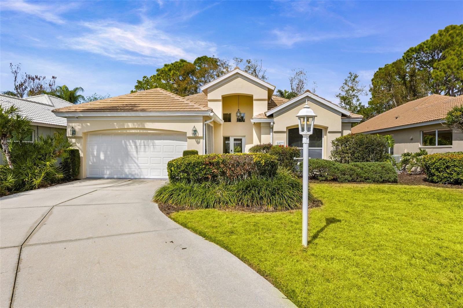 Highly desirable location in University Park Country Club! This wonderful home includes an inviting salt water pool and spa, surrounded by lush landscaping, offering both privacy and abundant sunshine, for the ultimate outdoor retreat. Soaring ceilings and an open floor plan maximize natural light throughout the spacious interior. The expansive primary suite is a peaceful haven, featuring a beautifully updated ensuite bath with a zero-threshold entry shower. Two additional bedrooms share a well-appointed bath, providing comfort and flexibility for family or guests. A new roof in 2025 and other upgrades add meaningful value and peace of mind. Ideally located near the University Parkway gate in Hampton Green, a premier enclave within University Park Country Club, this home offers both convenience and an exceptional lifestyle. HOA dues include professional landscaping, high-speed fiber-optic cable, and internet. Residents enjoy 27 holes of four-star rated golf, a full-service restaurant and bar, a state-of-the-art clubhouse and fitness center, as well as tennis and pickleball courts—all within this beautifully maintained, gated master-planned community.