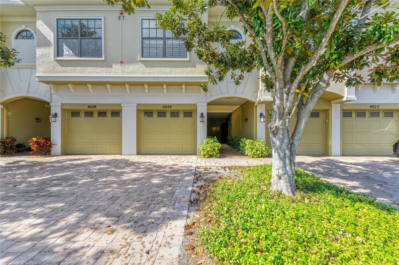 Price Improvement! Why is 4024 Overture Circle your perfect 3 bedroom/2.5 bath home?  Because it is unlike any other condo!  4024 Overture Circle is stunning and no detail to design and luxury has been overlooked — it has been completely renovated with almost $40,000 in high-quality upgrades. The home features beautiful, bright new flooring throughout, marble-tiled bathrooms with new vanities, and a freshly painted interior in warm, inviting tones. Modern comfort continues with a new air conditioning system under a biannual maintenance plan, new refrigerator, LG 75” TV, dishwasher, microwave, garbage disposal, and a hot and cold filtered water dispenser. Even the garage door opener, lighting fixtures, and smoke detector batteries have been replaced. A 220 V outlet for EV charging adds exceptional convenience for electric vehicle owners. This property's furniture is negotiable and can come beautifully furnished with quality Ethan Allen pieces, complemented by a luxurious Lazy Boy battery-operated recliner and tasteful accessories. Enjoy peaceful, year-round relaxation on the screened lanai, overlooking a serene pond frequented by ducks and birds — with no alligators in sight. 4024 Overture Circle is truly a premier, move-in-ready home that offers both elegance and ease of living while being just a couple of miles from the beautiful sugar sand beaches and island charm of Anna Maria Island!  Come see it today.  You won’t believe your eyes!