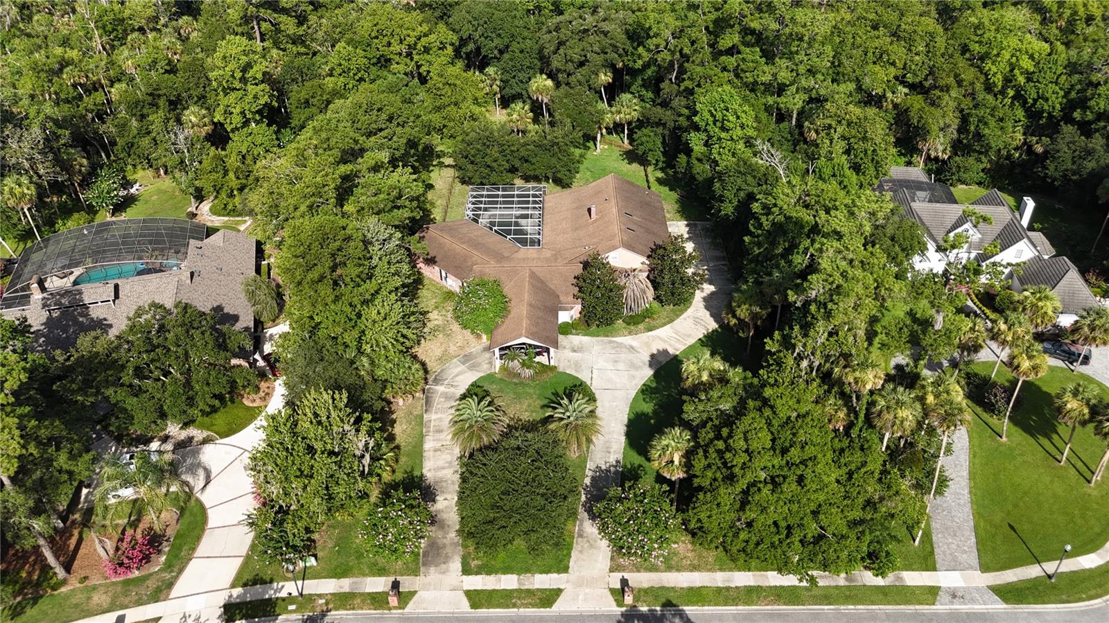 Short Sale. Short-sale opportunity on 1.71 acres in one of Longwood's most desirable conservation-backed communities — priced at $1,100,000 to reflect condition and reward the right buyer. Tucked at the end of a quiet cul-de-sac, this custom-built single-story estate offers approximately 4,688 heated square feet with tremendous bones and even greater upside. This is a pre-foreclosure short sale being sold strictly AS-IS. The property requires renovation, including interior finish work — an ideal project for investors, builders, or an end-user ready to restore this home to its full potential.
The layout is exceptional: 5 bedrooms, an executive office, a spacious upstairs loft and study, and a primary suite on the main level. A dramatic screened lanai spanning roughly 72 feet wraps around a private salt-water pool and spa, with a backyard fire pit and peaceful conservation views beyond. A circular driveway, 3-car garage, and carport add to the appeal, all set on a sprawling, oversized lot.
Located in a top-rated Seminole County school district (Woodlands Elementary, Rock Lake Middle, Lyman High) and minutes from Markham Woods Road, this is a rare chance to own significant acreage and square footage in a premier location at a value price. Sold AS-IS; buyer to verify all information, condition, and measurements.