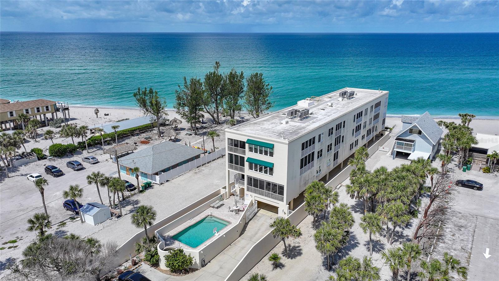 Welcome to Krystal Key Condominiums, an exclusive, gated enclave on the pristine shores of Manasota Key where luxury, privacy, and laid-back elegance converge. This exquisite 2-bedroom, 2.5-bath residence is a rare gem—offering all the sophistication of high-end coastal living while embracing the serenity of the Gulf Coast. This building made it through all storms practically un-scathed, like a local Fort Knox. Enter through your privately gated drive and enjoy the convenience of two assigned covered parking spaces tucked beneath the building—shielded from the elements and secured for peace of mind. A private elevator delivers you directly to a semi-private grand foyer, which can be key-locked for enhanced security and exclusivity. Step through double entry doors into a space designed to impress. The open-concept layout is enhanced by PGT impact-rated tilt-and-turn windows and sliders that bathe the home in natural light while offering effortless views of both the Gulf of America and Lemon Bay. Relax in the inviting living area anchored by a modern glass crystal fireplace—a shimmering statement of both warmth and sophistication. The chef-inspired kitchen is a culinary dream: featuring a massive quartzite island, Bosch stainless steel appliances (including induction range, warming drawer, and refrigerator), a Houzz apron-front sink, extensive cabinetry, and a custom-built pantry with pull-out drawers. Adjacent, a charming media/family room with built-in shelving provides the perfect space to unwind or entertain. Both bedroom suites are luxuriously appointed with walk-in closets and private baths. The primary suite boasts a spa-like experience, featuring dual vanities, a steam shower, and a deep soaking tub. Step onto either of the two expansive private balconies to enjoy partial Gulf views and the soothing sounds of the surf. The primary balcony also includes hurricane roll-down shutters for added protection and convenience. Additional features include: • Impact glass throughout • Custom chef’s desk with quartzite surface • Elegant finishes and designer touches in every room • Access to a saltwater community pool, heated spa, and outdoor grilling area • Keypad entry, security cameras, and guest parking • Just a short stroll to Stump Pass State Park, restaurants, and charming island boutiques Whether you're seeking a full-time residence or a seasonal escape, this home offers unmatched comfort, security, and coastal beauty. Live where others vacation. Showings by private appointment only. **PLEASE ENJOY THE 3D INTERACTIVE VIRTUAL TOUR ASSOCIATED WITH THIS LISTING**