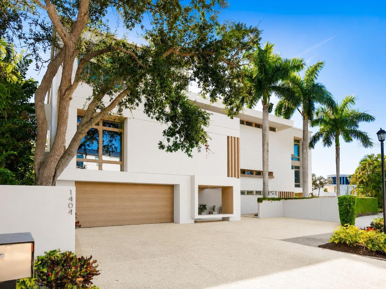 Privately positioned in gated Oyster Bay Landings with water views stretching down a short canal to Sarasota Bay, this stunning iconic masterpiece from world-renowned architect Guy Peterson is a breathtaking example of the Sarasota School of Architecture’s style and vision. A comfortable modernistic ambiance flows freely throughout the 5,428 sq. ft. of open living where walls of glass capture spectacular displays of the cerulean blue water and evening skies of fiery beauty. No detail has been overlooked. No expense has been spared. Architecturally striking, this 4-bedroom, 4.5-bath waterfront residence is the ultimate indulgence offering rarity, cachet and grandeur. Dock with 2 lifts is conveniently situated on a waterway unencumbered by any bridge. Floor to ceiling windows frame expansive vistas and abundant natural light complements the thoughtfully-appointed and expertly-planned space. Over 4,000 square feet of outdoor area is inviting and festive, and presents unique vantage points to deliver an exhilarating experience. Expansive terraces promote seamless indoor-outdoor living. Covered entertaining is abundant among the verdant tropical gardens and immaculately manicured grounds. Resort-style amenities including an elevator, courtyard with fire pit and heated pool/spa, and breathtaking reflecting pool with fountain. The stunning kitchen is a culinary delight and complemented by an extravagant amenities package of top-tier appliances, island with seating for 6, 20-ft. long counter for 2 desk workstations, side-by-side but separate refrigerator and freezer, 2 dishwashers, and deep walk-in pantry. The family room is equipped with built-in entertainment wall and opens to a waterfront patio with outdoor cooking center. The great room has travertine floors and cypress ceiling detail, and the office provides a desk with stone countertops and plenty of solid wood cabinetry. A 400-bottle wine room is the highlight of the gaming area with wet bar, electric shades and unique glass chandelier. On the second level are spa-inspired en-suite bedrooms with custom closet systems and elevated ceilings. A 30-ft. bridge leads to the master wing highlighted by incredible water views, sitting room with morning bar, and home gym/office. The primary bath creates an immersive experience with a 16-ft. long dressing hall with a wall of built-ins and mirrors, large walk-in specialty closet, multi-faceted shower, deep soaker Jacuzzi tub, separate bidet and laundry chute. In addition, there are two laundry areas, an elevator from ground level to the 2nd and 3rd floors, Creston music and lighting system, Generac generator, and 4-car garage. In one of Sarasota’s most coveted locations along the waterfront, this home redefines coastal living is just minutes from beaches, golf, fine dining and downtown Sarasota’s beloved arts and cultural offerings. When scheduling your exclusive tour of this amazing MODERN waterfront estate, make sure to allow plenty of time for exploring its incredible features, both inside and out. It must be seen in person to be fully appreciated. Even the most discerning buyer will fall in love!