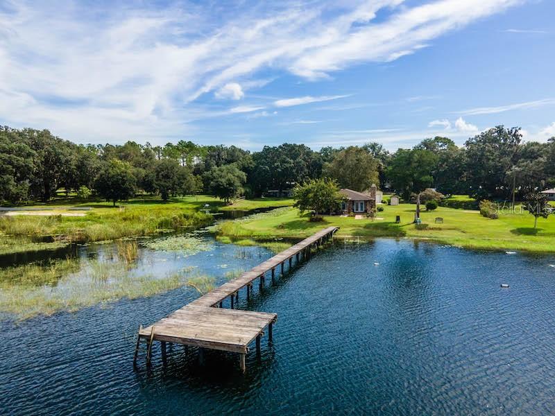 Stunning Lake Kerr sunsets included on this hard to find .87 acre lot. 125' of lake front with dock and over 300' of canal front, wrapping around the property. Almost like living on your own island. The home features 1187 square feet, 2 bedrooms, 1.5 bathrooms, concrete construction with brick and was originally built in 1987(builders personal home for many, many years). Upon entering the home you will see an open floor plan with beautiful lake views through double french doors. Kitchen includes tiled floors, lots of custom wood cabinets and granite countertops. Living room has wood burning fireplace and brick accent wall with waterproof vinyl flooring throughout including bedrooms. Bathroom has warm country feel with cool double sink vanity, steel tub and tiled surround. Garage is 30'x30' and currently being used as additional living quarters or entertainment room with 1/2 bath. Living room french doors lead to covered rear porch and both covered and open patio perfect for relaxing and enjoying spectacular lake views. Outside there is 30'x30' concrete block garage which is perfect for all your toys. 

Lake Kerr is approx. 2800 acre spring fed lake and 2nd largest lake in Marion County. Located in the Heart of the Ocala National Forests. Lake Kerr also has access to Little Lake Kerr(Lake Werner). Some of the best fishing in Central Florida with largemouth bass, bream, catfish, specks and more to challenge you daily. Unique shape of lake lends great opportunities for every kind of watersports including wakeboarding, waterskiing, canoeing, kayaking, tubing or just going for relaxing boat cruise. There is only one public boat ramp(Morehead Park) with beautiful Kaufman Island located in the middle of lake. 

Located in the heart of the Ocala National Forest w/ beautiful Salt Springs swim area, boat launch and short ride to Lake George and the St. Johns River. Salt Springs is also home to miles and miles of ATV/SxS, Horseback and hiking trails. Great fishing year round in the many lakes, rivers and forest ponds, and don't forget about the excellent hunting too. Close to local shopping including grocery store, Dollar General, hardware, gas station, great restaurants, entertainment and more. Only short 30 minute drive to Ocala or Palatka for all your needs.