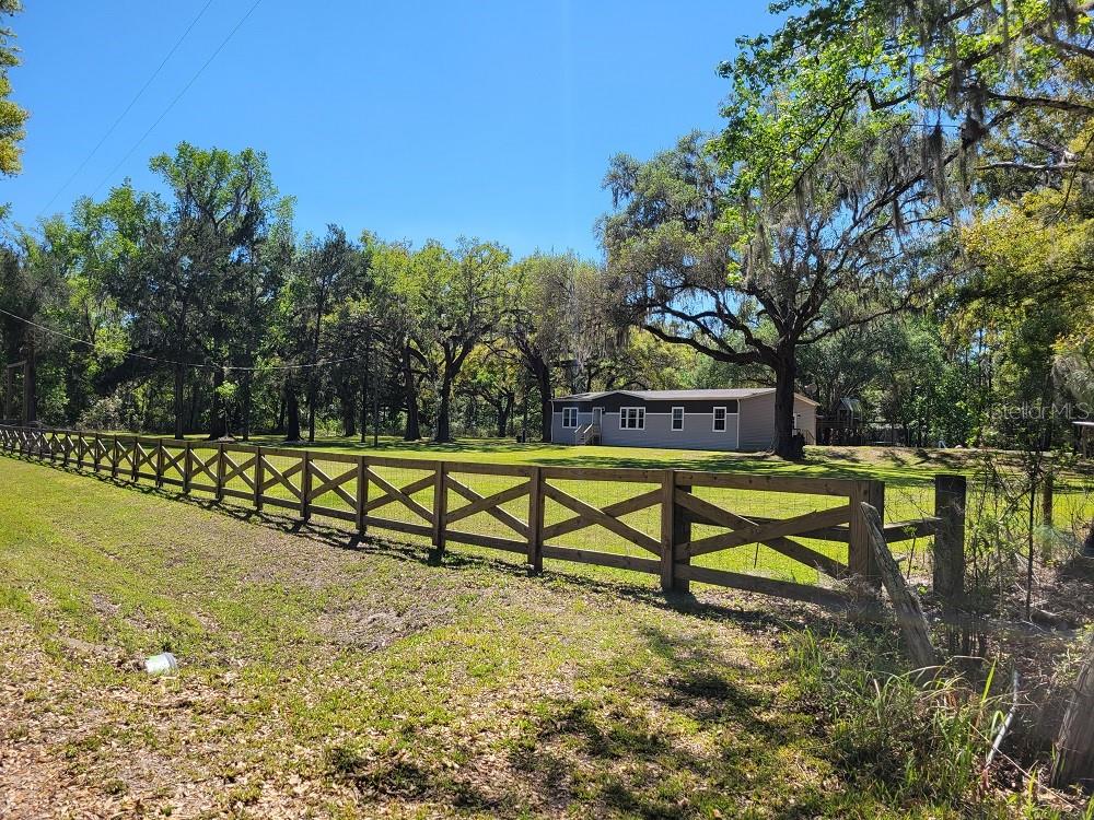 Opportunities with this 3-bedroom 2 bath home w/ Large shop on 16.8(mol) Acres. Five total parcels. Must be sold all together. 
Are you looking for privacy, a retreat, a family compound, or want to bring your business home. Want to be on the Good Neighbor bike trail? This is the perfect property to make that dream a reality. Let’s start with the manufactured home that was built in 2021. This 3 bedroom, 2 bath home has 1,920 sqft. of space. The beautiful living room has lots of space for family gathering and Holiday get togethers. Birthday parties are a must. The kitchen offers all the modern conveniences you have come to expect, stainless steel appliances, farm sink, and more counter space than most restaurant kitchens. Primary bedroom features plenty of room to spread out and relax. This room features a huge walk-in closet. Primary bathroom offers a dual sink vanity, separate water closet, and a gigantic walk-in shower. This home boasts a Split floor plan. These two rooms are also plenty big with closets to store all kinds of goodies. Back porch measures 20x45 and is the perfect place to enjoy morning coffee and watch wildlife start the day. Pool parties would not have a better place to happen than this well laid out area. The home also has a 20x16 storage shed. Across the drive in a huge 6420 total square foot storage building. A great place to store your vehicles, expensive toys, or workshop. The total shop is 30’x214’ and the enclosed area is 4980 total sqft. It has 4 areas that are 10x10, one spot 8x8, one stall 16x13 and the last one is 20x13. Concrete floors measure about 6480 sqft. The possibilities are endless with this property. There is even a pond on the property. Try your luck on your own fishing spot. The covered dock is 20x36 and is a great place to enjoy sunsets and evening cocktails. There is another structure on the property that could be transformed into just about anything you could image. It was an old homestead that will need refurbishment. With this kind of acreage, anything is possible. There is even a 3.3-acre(mol) commercial piece of property that is included with this deal. Run your business from here. Owner financing available. The opportunities that this property affords is only limited to your imagination. Beautiful scenic landscape, close to major roads that connect you to shopping, entertainment, restaurants and yet far enough away to enjoy the private Brooksville countryside.  ****Properties like this don’t come around very often, so act today as this will not last long. Make your appointment today!!**** Please verify all measurements, zoning and FEMA codes. Owner financing may be available.