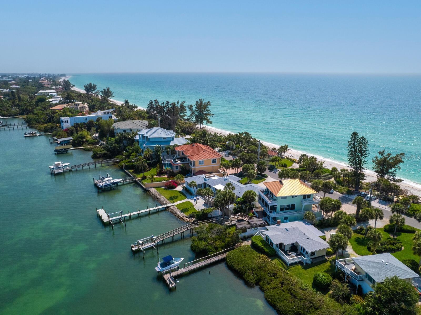 Casey Key on your list of places to live?  Imagine waking up to the sun rising over the bay and stepping out onto your own private sandy beach. The incomparable views of the Intracoastal Waterway and the Gulf of Mexico are breathtaking. This Gulf-to-bay property offers the best of waterfront living on Casey Key's natural eight-mile barrier island. The vintage cottage has been impeccably maintained and is move-in ready, featuring a spacious living room, two bedrooms, an office/possible third bedroom, and a dining area overlooking Blackburn Bay. Outside, a quiet deck and dock with a 10,000-pound boat lift installed in 2021 provide some of the deepest boating water in the area for all your water adventures. With a new roof in 2023, fresh paint, and enhanced landscaping, there's so much to love. Whether you're enjoying the home or considering building a new one, we can assist with a carefully curated list of architects and builders. Casey Key, with private air travel just 15 minutes away at the Venice airport and 30 minutes to Sarasota International, caters to every imaginable lifestyle, offering nearby shopping, dining, golf, and more. This charming beach house and slice of paradise could finally be yours!