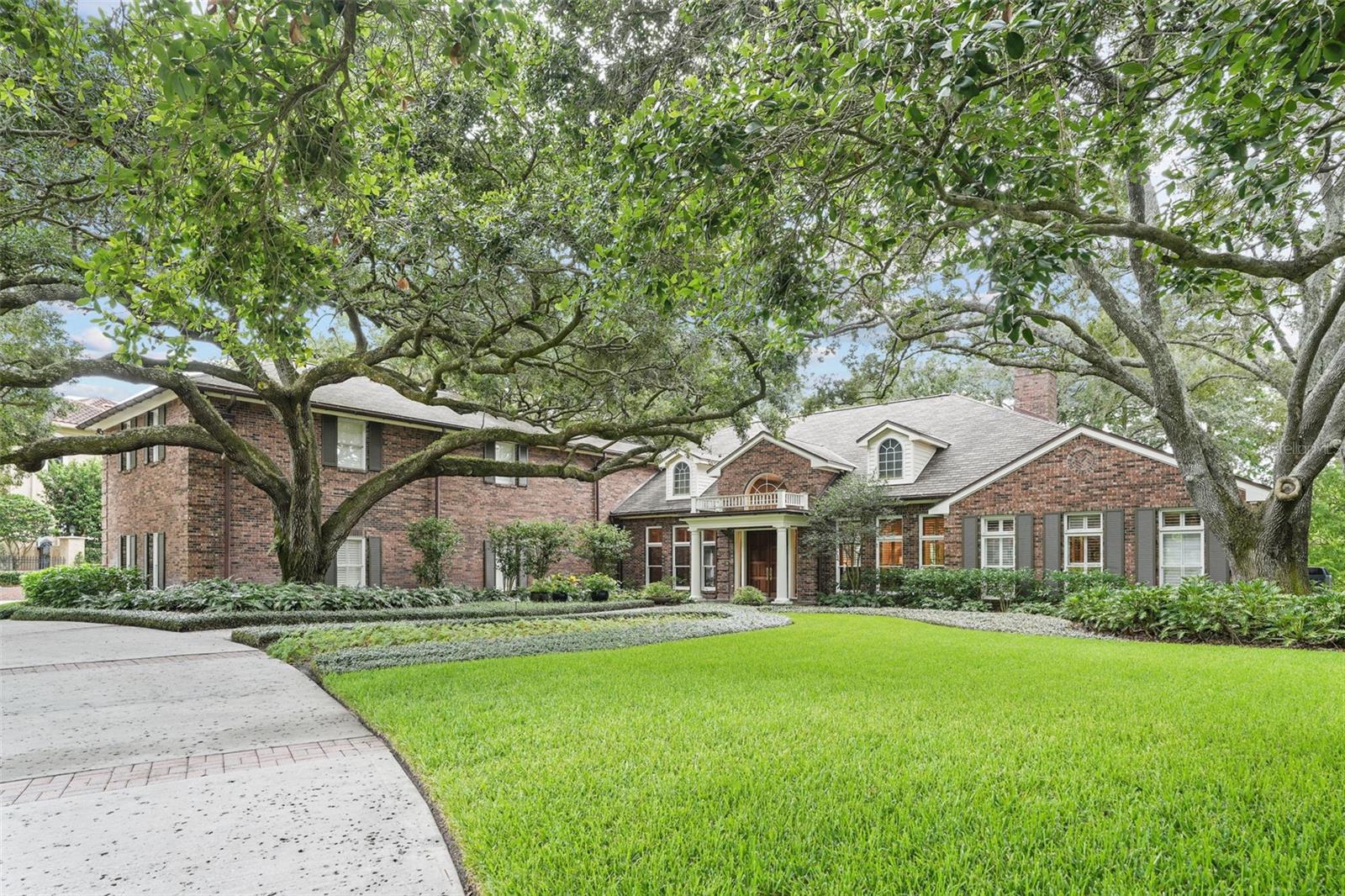 LOCATION. PRIVACY. A FLOOR PLAN THAT LIVES WELL.
Set within AVILA, one of Tampa Bay’s guard-gated communities, this 2-story brick estate sits on a 1.12-acre pond-front homesite with mature trees and enhanced landscaping. Designed with most living on the main level, the home offers openness and everyday functionality. Being sold furnished.
THOUGHTFUL FLOOR PLAN: Offering approx. 6,656 SF, this 4-bedroom, 4.5-bath residence is designed to be open and easy to live in. The main level features a primary suite, secondary bedroom with adjacent full bath, dedicated study, and living areas that flow naturally from room to room. Upstairs includes 2 en-suite bedrooms and a bonus room.
MAIN LIVING SPACES: The main level offers interconnected spaces that feel open yet defined. Formal and casual rooms transition seamlessly, allowing gatherings to flow comfortably. Wood and stone flooring, crown molding, plantation shutters, and expansive windows bring in natural light and frame pond views.
LIVING & ENTERTAINING: The formal living room provides an elegant setting for hosting. The family room, highlighted by a coffered wood ceiling, captures pond views and serves as the heart of the home. A separate fireplace room creates an inviting retreat for conversation or quiet evenings.
FORMAL DINING ROOM: Ceiling details and trim create a polished setting suited for intimate dinners or larger gatherings, with glass doors opening toward the outdoor living space.
WINE ALCOVE & SITTING AREA: An architectural wine alcove with exposed brick, wood detailing, and herringbone brick flooring serves as a focal point and flows into a sitting area designed for entertaining.
KITCHEN & DINETTE (2016): Anchored by a copper range hood, the kitchen features an oversized island, breakfast bar seating, vegetable sink, gas range with ovens, built-in wall oven and microwave, 2 Bosch dishwashers, and Sub-Zero refrigerator. The dinette overlooks the vaulted screened patio and pond setting.
PRIMARY SUITE (MAIN LEVEL): Privately positioned with arched doorways, wood flooring, crown molding, gas fireplace, custom walk-in closet, and renovated marble bath with soaking tub and glass shower (2016).
DEDICATED STUDY: Built-in bookcases, ceiling detail, plantation shutters, and wood flooring create an ideal home office or library.
UPSTAIRS LIVING: 2 en-suite bedrooms and a bonus room offer flexible space for media, play, or additional living needs.
OUTDOOR LIVING & GARAGE: The vaulted screened patio features a wood ceiling, slate flooring, built-in grill, and pond views. Landscaping enhances privacy and extends the interior living space. 3-car garage with additional storage.
AVILA COMMUNITY: Residents enjoy 24-hour guard-gated security, park, playground, recreation field, basketball and pickleball courts, dog park, pavilion, and walking path. Optional membership available at the Avila Golf & Country Club.
A private estate offering space, security, and a layout designed for everyday living and entertaining.