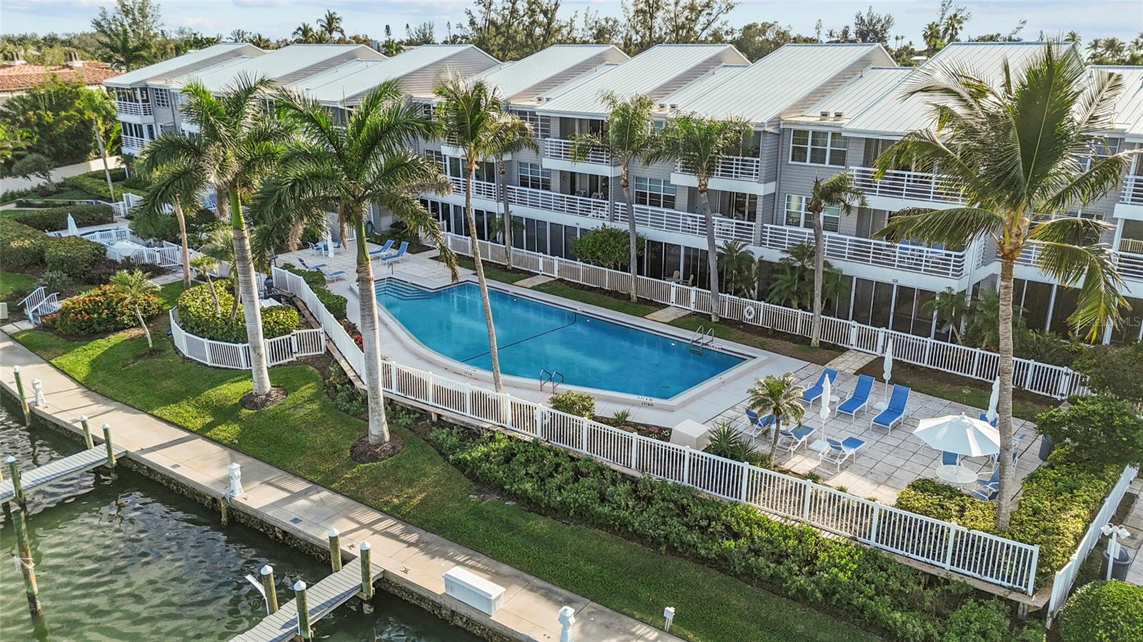 Paradise Found: Fully Renovated Luxury at Harbour Villa Club, a True Longboat Key Gem! Welcome to a slice of heaven on the pristine North-End of Longboat Key at Harbour Villa Club. This luxurious, fully renovated (2025, not from storms) waterfront condo offers a lifestyle of serene elegance, perfectly positioned to capture breathtaking, unobstructed views of the glistening Sarasota Bay, the Intracoastal Waterway, and the protected Sister Keys. Step inside this exquisite home to an open, spacious floor plan bathed in natural light, thanks to high ceilings and expansive sliders. The custom gourmet kitchen is a chef's dream, featuring top-of-the-line appliances, ample counter space, and intelligent, creative storage solutions. The main living area is complemented by a sleek and stylish wet bar, ideal for effortless entertaining.
The primary suite is a private sanctuary, designed for ultimate comfort with tremendous space, dual closets, and unparalleled water views. The equally luxurious primary bathroom features high-end fixtures, beautiful tile work, and a spacious shower. The secondary bedroom provides a generous space perfect for use as a guest suite or a flexible office. Relax or entertain year-round on your covered and screened lanai, the perfect outdoor space for sipping your morning coffee or evening cocktail while taking in the surrounding beauty.
Boater's Dream and Unrivaled Flexibility: A rare and highly valuable amenity is the deeded boat slip #14, which conveys with the condo. This 40ft slip, equipped with electric, water, and new composite decking, is positioned directly outside the unit and can accommodate up to a 55'+/- vessel. Furthermore, Harbour Villa Club is one of the few Longboat Key communities with Weekly rental allowance, offering exceptional flexibility for ownership and use. Potentially generating gross approx. income of $85K annually with generous owner use availability. 
Community & Location: The community boasts mature tropical landscaping and grounds. Amenities include a heated pool, hot tub, outdoor grill, kayak storage/launch, boat ramp, climate-controlled bicycle/locker storage, and brand new tennis and pickleball courts. Located just a short walk to popular beaches, restaurants, and parks, and a short drive to St. Armands Circle and Downtown Sarasota. This property is more than a luxury condo—it is a complete lifestyle.